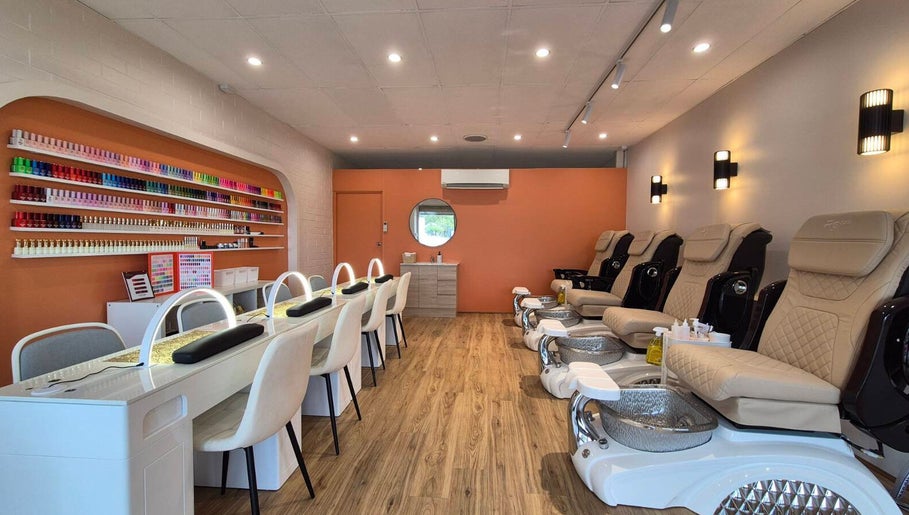 Modern interior of Sala Nails & Spa in Gosnells, Western Australia, AU with cream chairs and nail polish display.