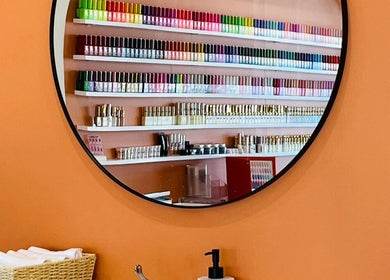 Vibrant nail polish shelves reflected in a mirror at Sala Nails & Spa, Gosnells, Western Australia, AU.