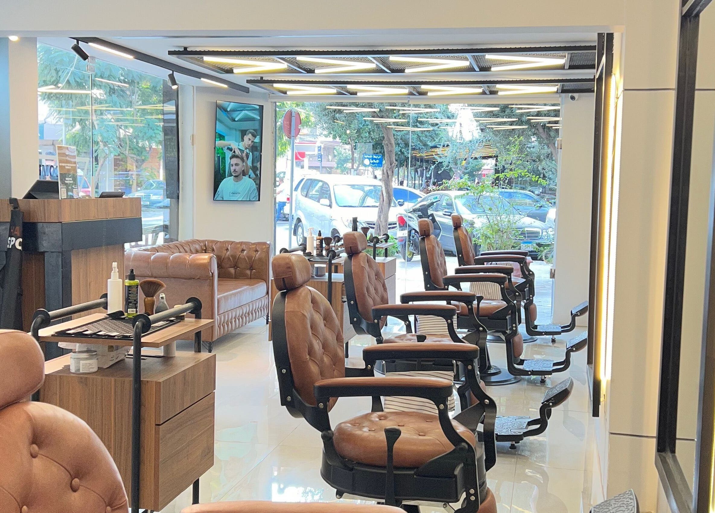 Elegant interior of Hair Spot in Tarablus, North Governorate, LB with stylish chairs and lush greenery.