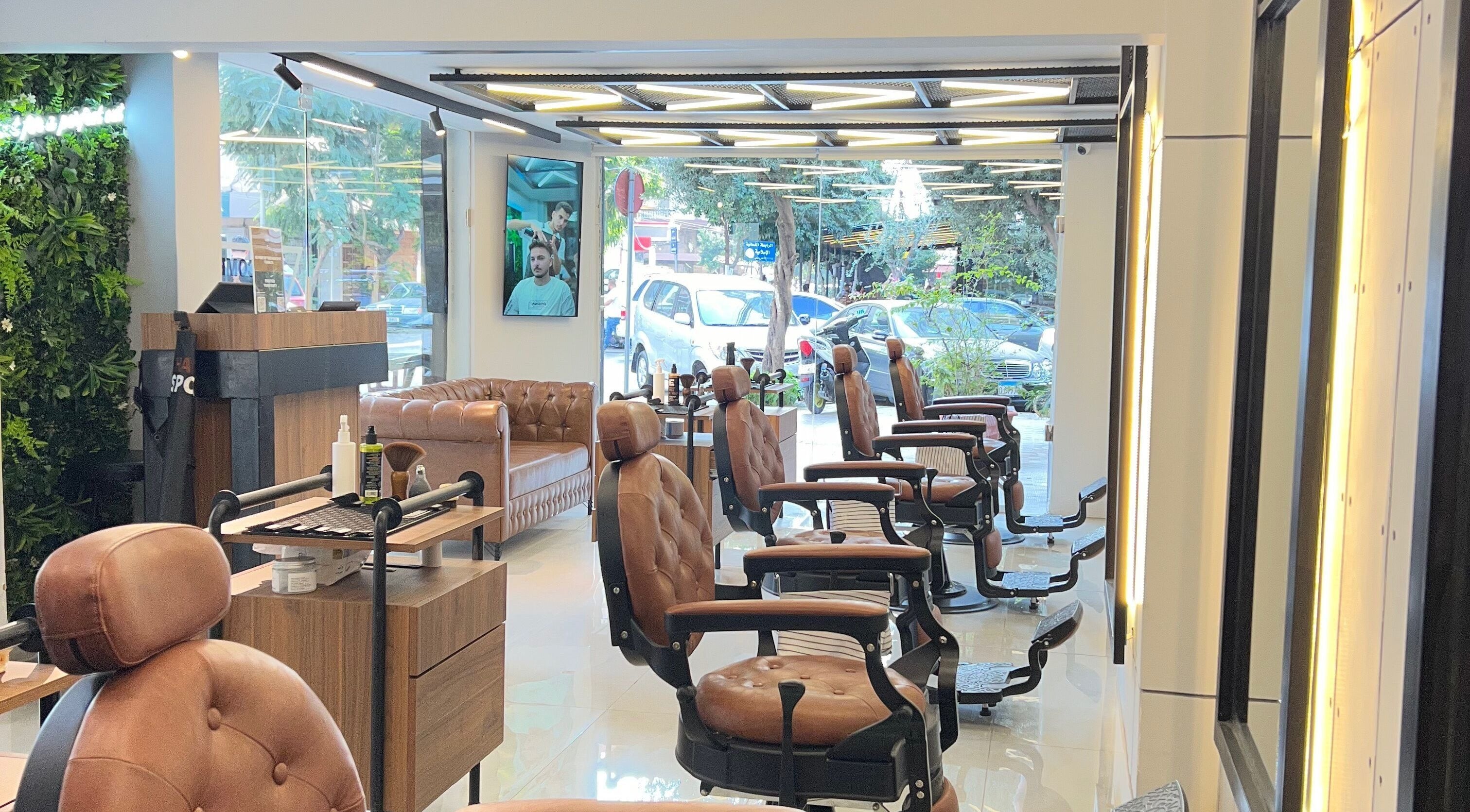 Elegant interior of Hair Spot in Tarablus, North Governorate, LB with stylish chairs and lush greenery.