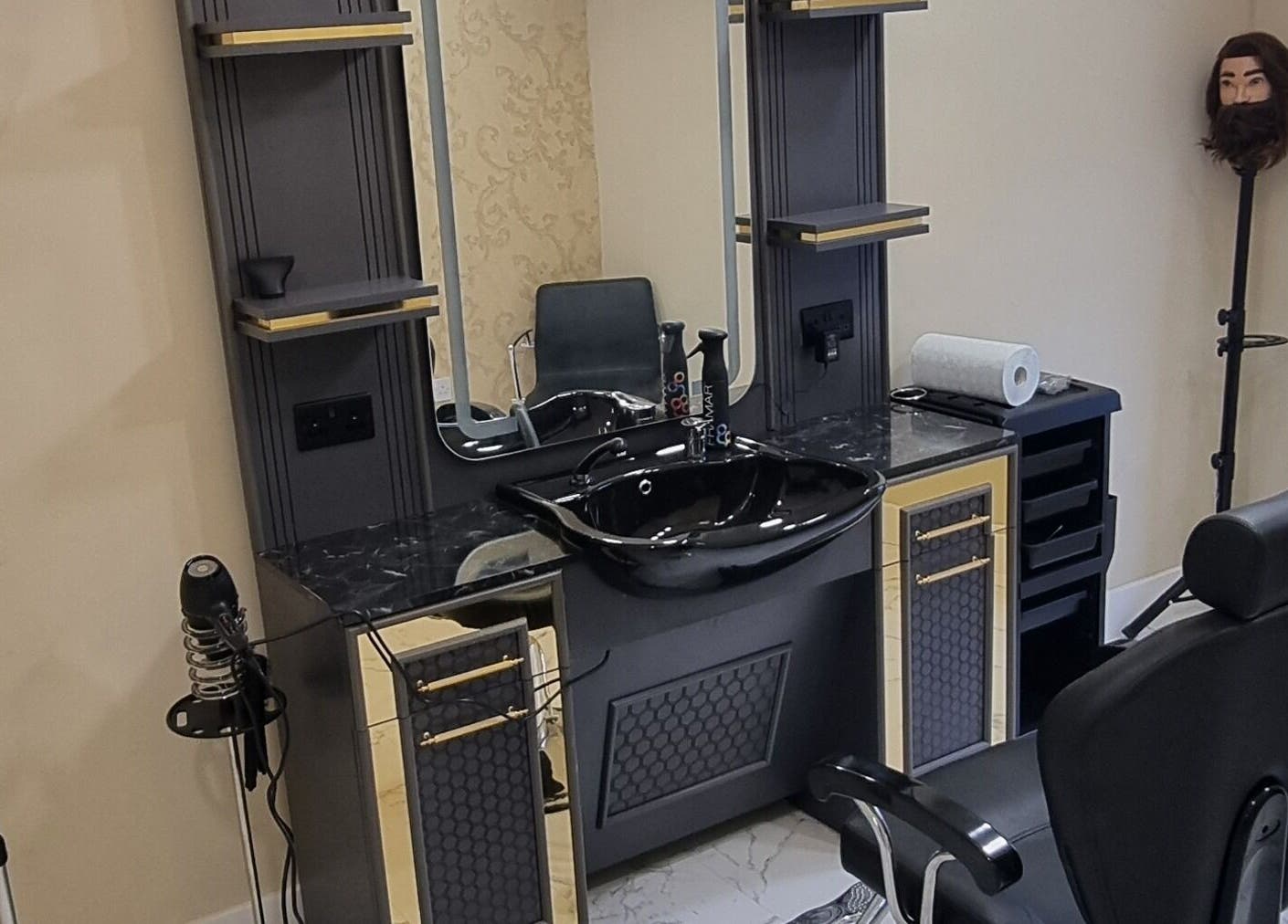 Barber station at Charles Hair Reaper Ponteland, featuring a sleek black sink in Ponteland, England, GB.