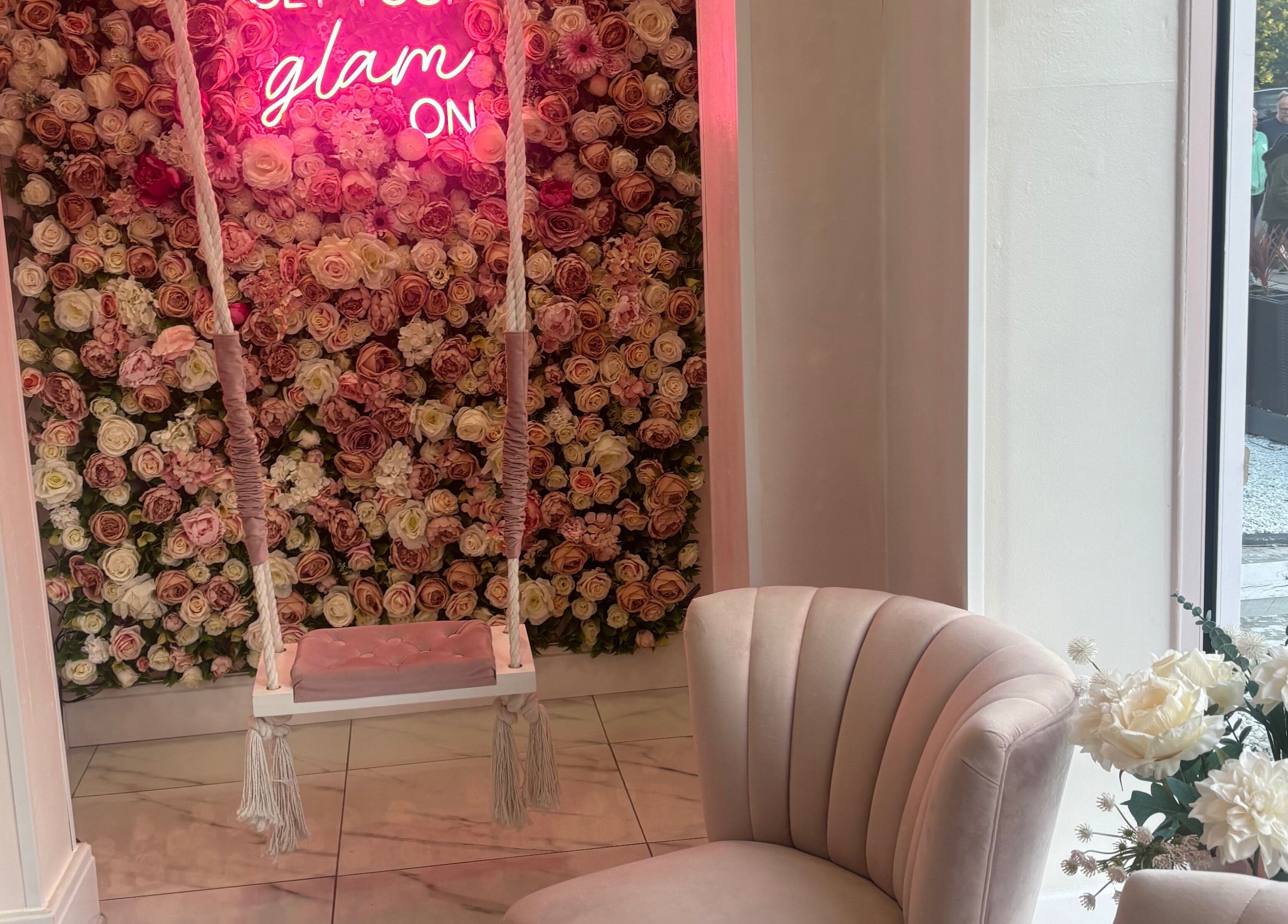Luxury Beauty Salon in Bromsgrove, England, GB features a floral backdrop with swing and plush seating.