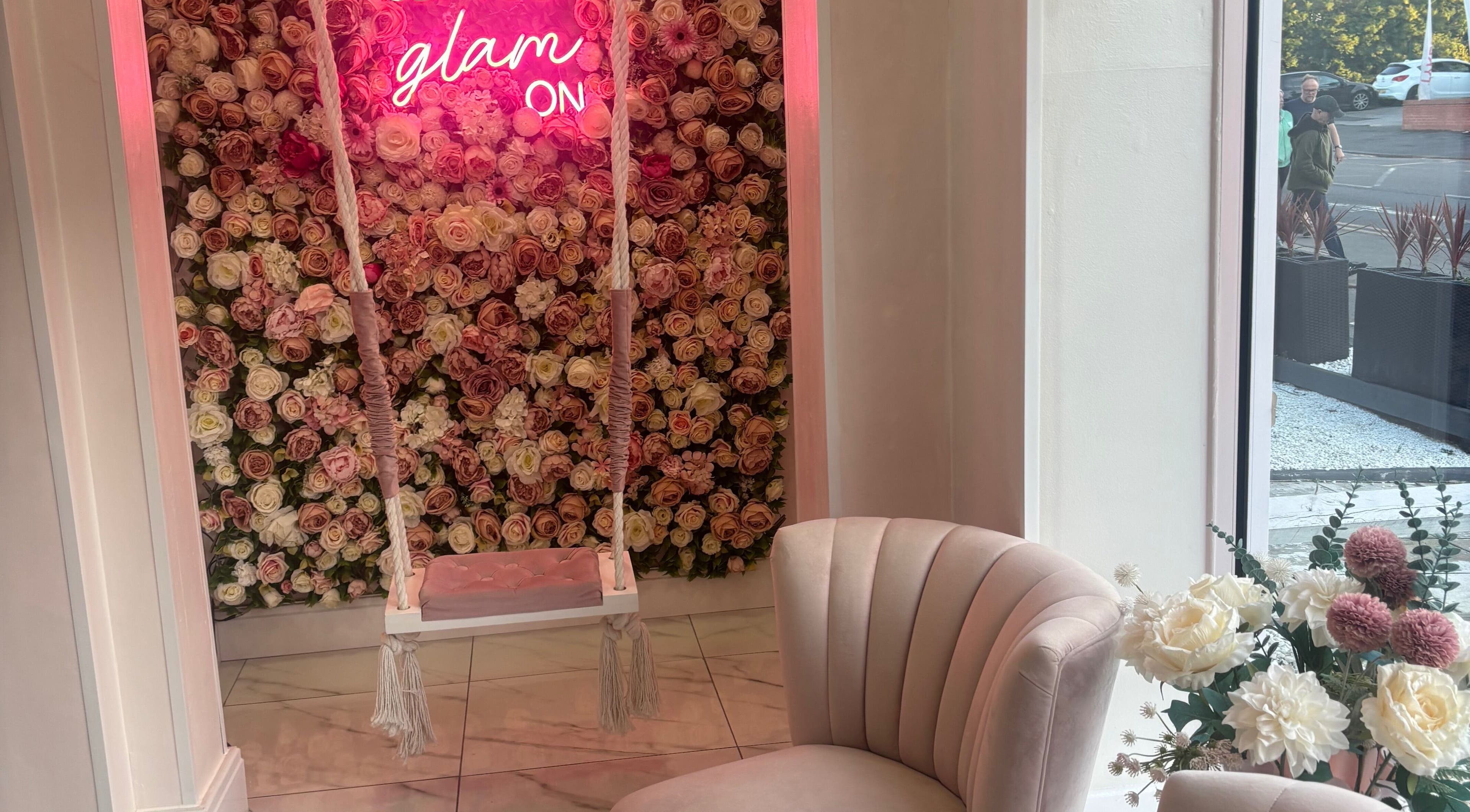 Luxury Beauty Salon in Bromsgrove, England, GB features a floral backdrop with swing and plush seating.