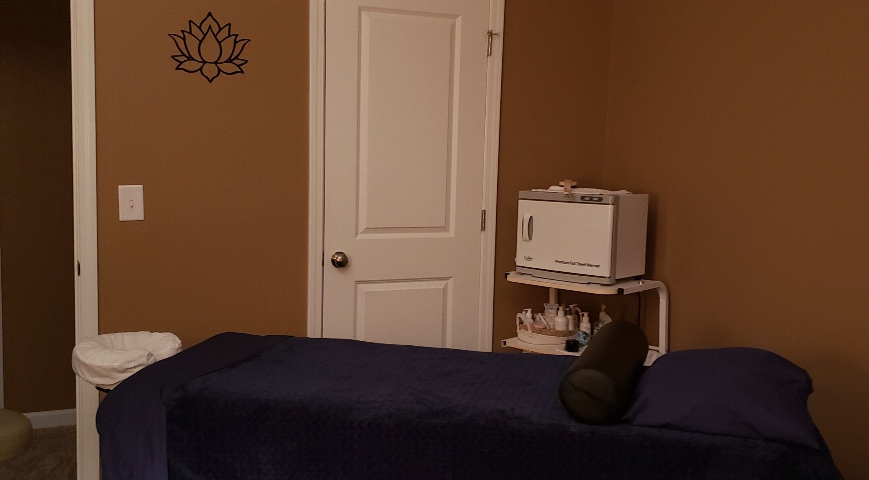 Relaxing massage room at SpaZen, Fort Mill, South Carolina, US with cozy massage table and warm lighting.