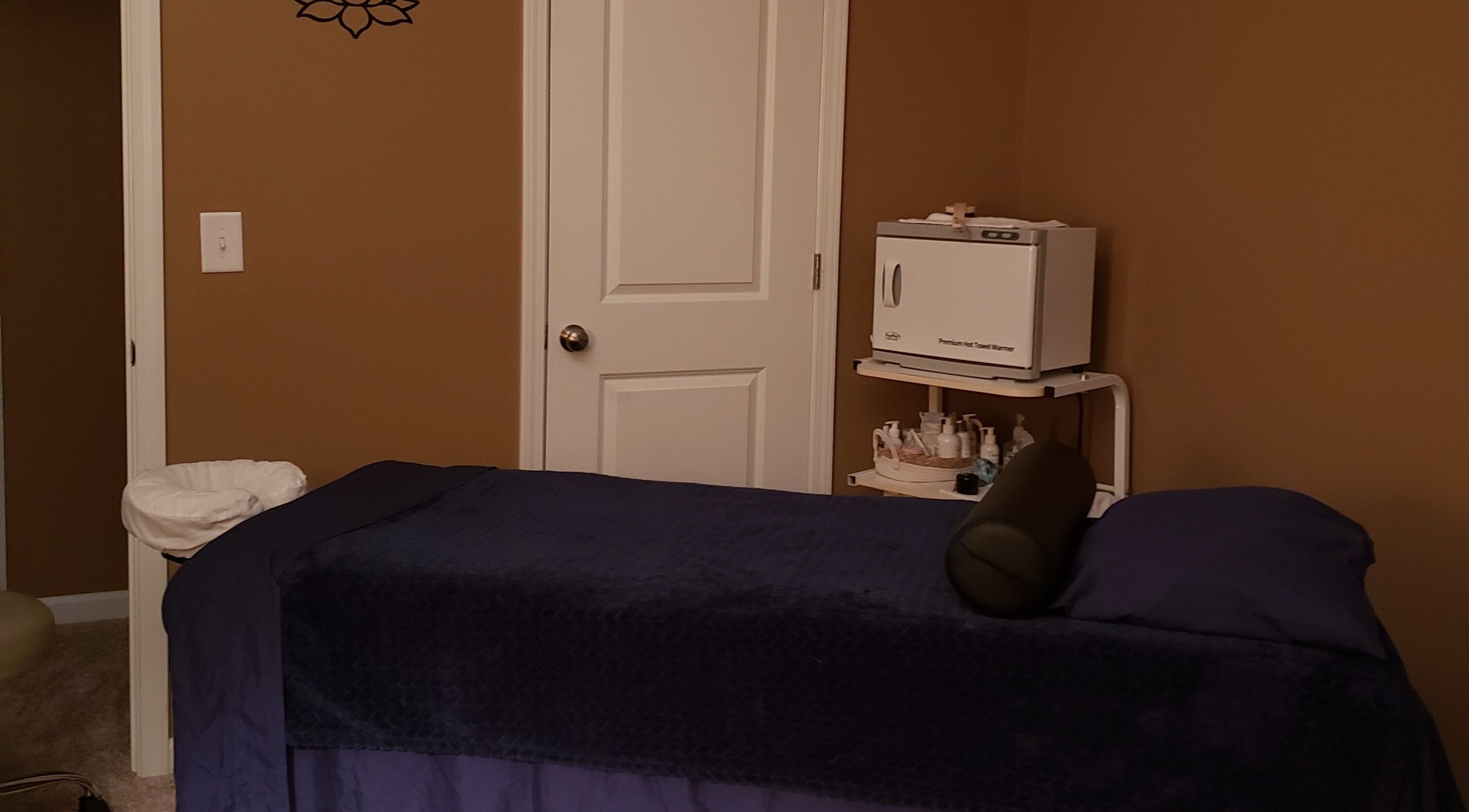 Relaxing therapy room at SpaZen in Fort Mill, South Carolina, US with massage table and warm tones.