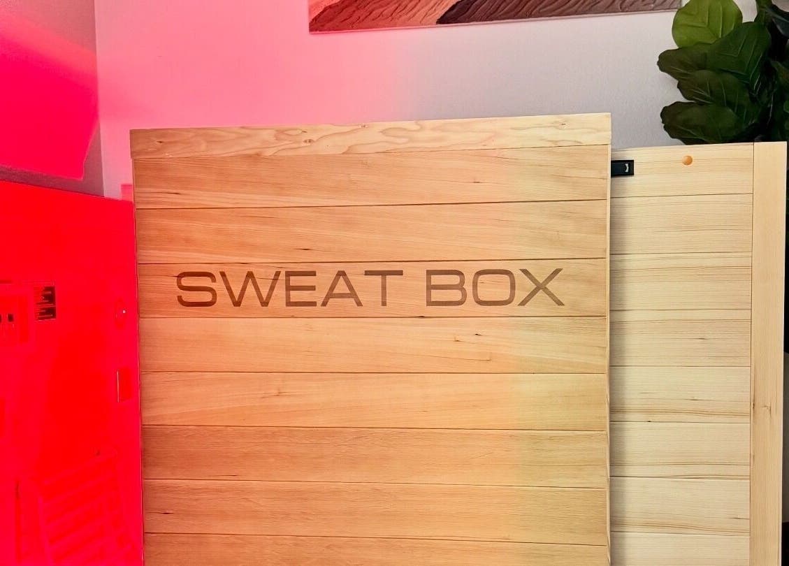 Sweat Box at EverGlo Studios in Henderson, Nevada, US, featuring warm wood panels and vibrant lighting.