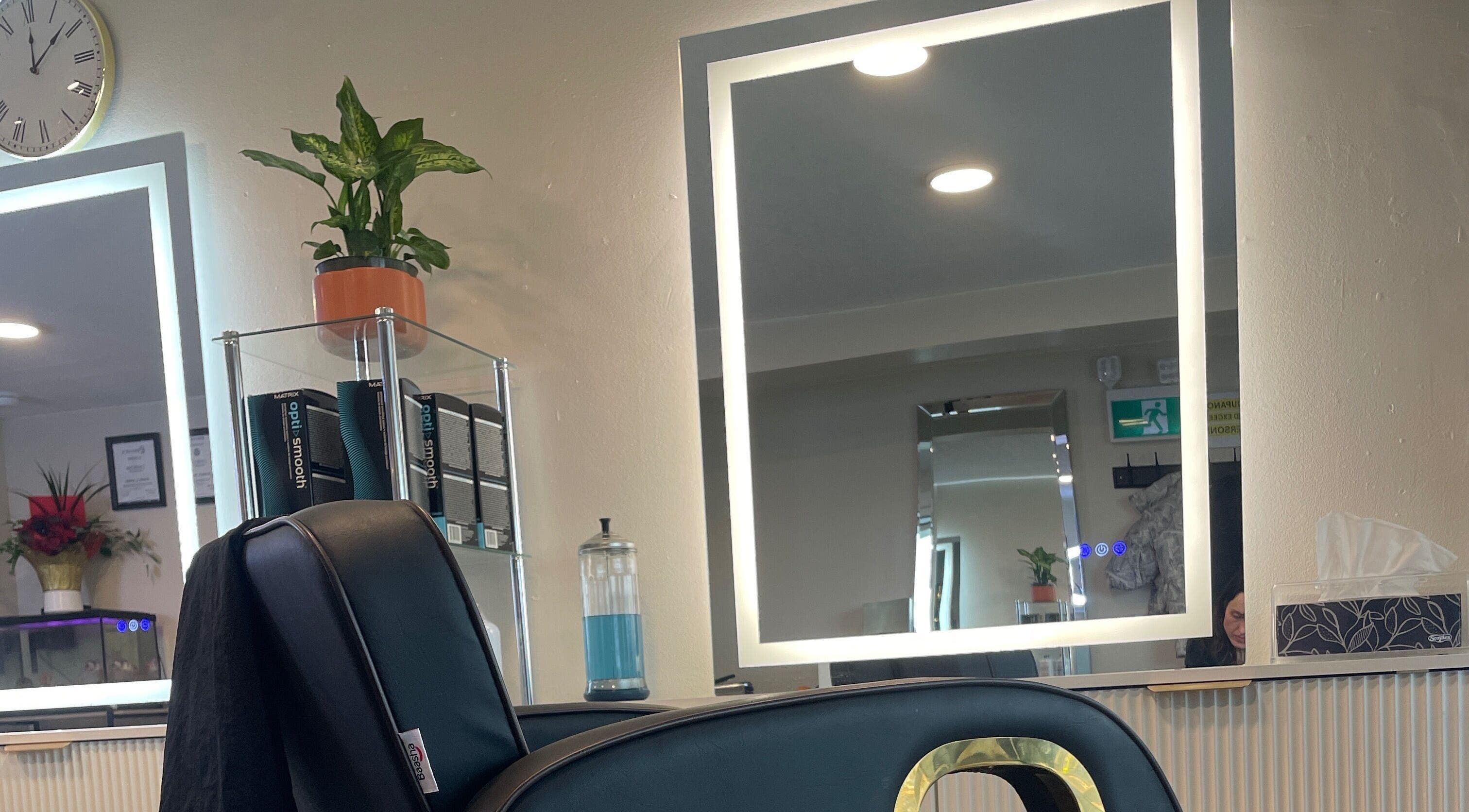 Elegant salon station at Hair By Alyssa, Nanaimo, British Columbia, CA with mirror and styling chair.