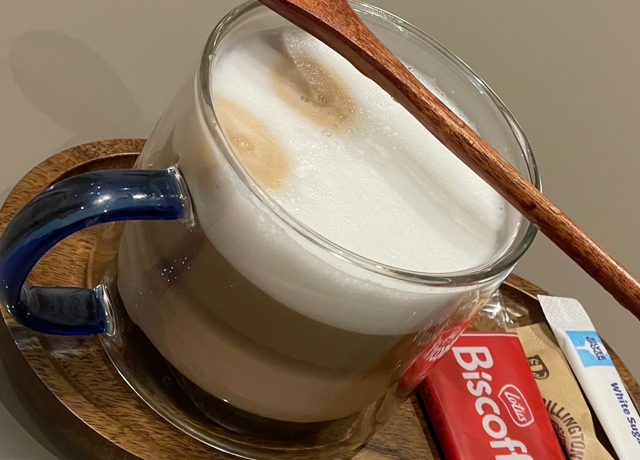 Warm latte with a wooden stirrer at Nail Room By Emilia, Bletchley, England, GB.