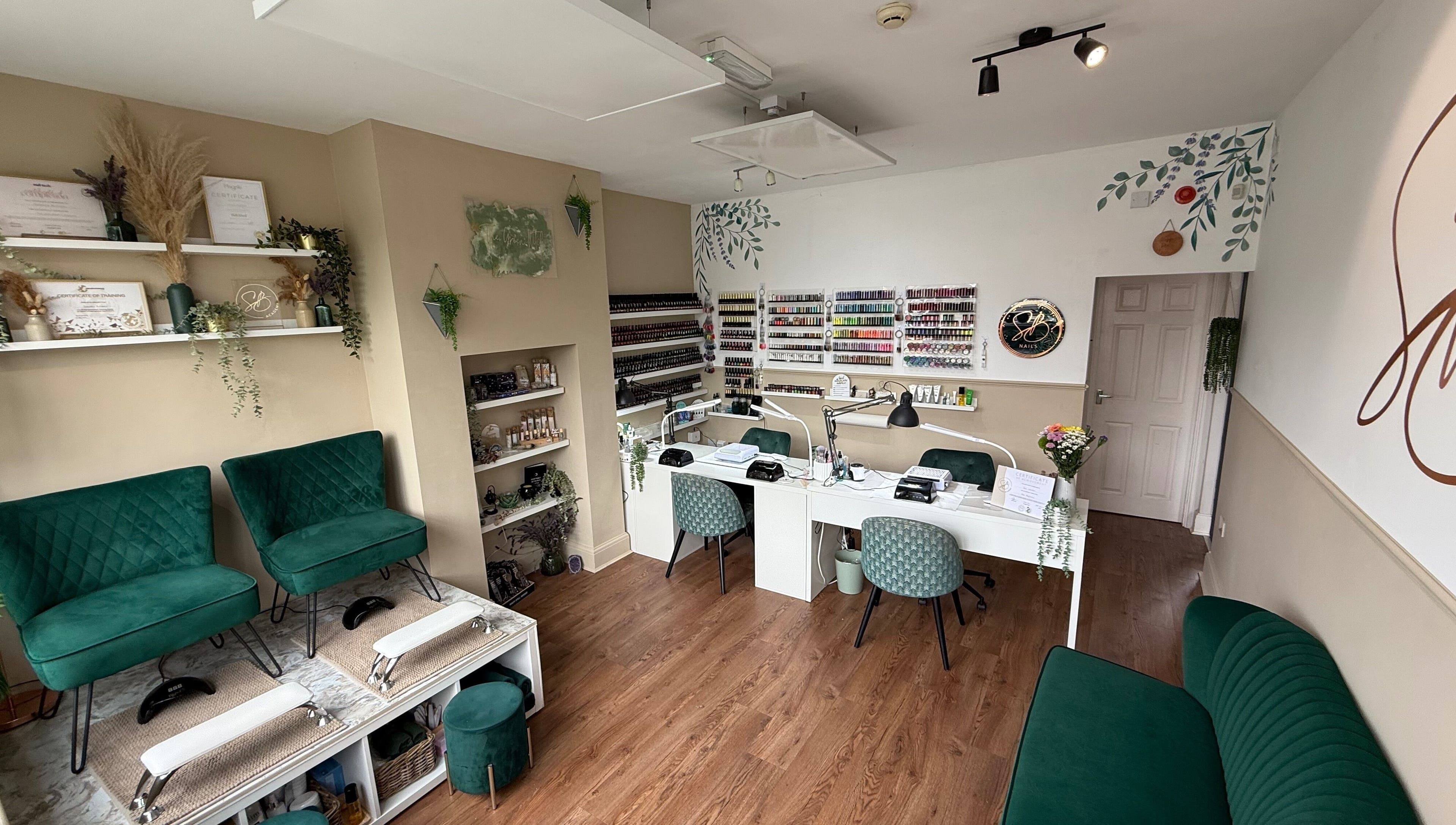 Chic nail salon interior at SB Wellbeing / SB Academy, Chesterfield, England, GB featuring stylish seating and polish display.