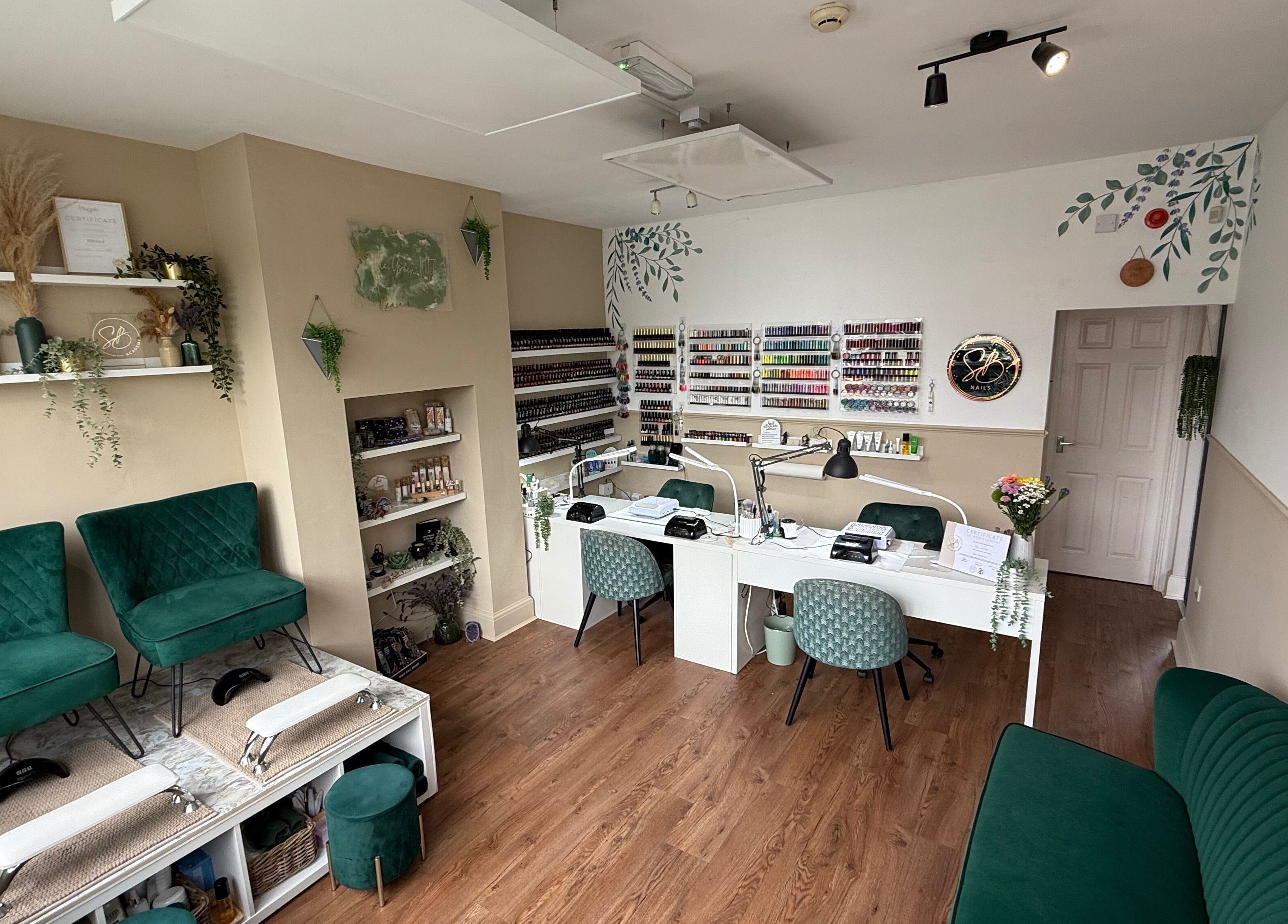 Chic nail salon interior at SB Wellbeing / SB Academy, Chesterfield, England, GB featuring stylish seating and polish display.