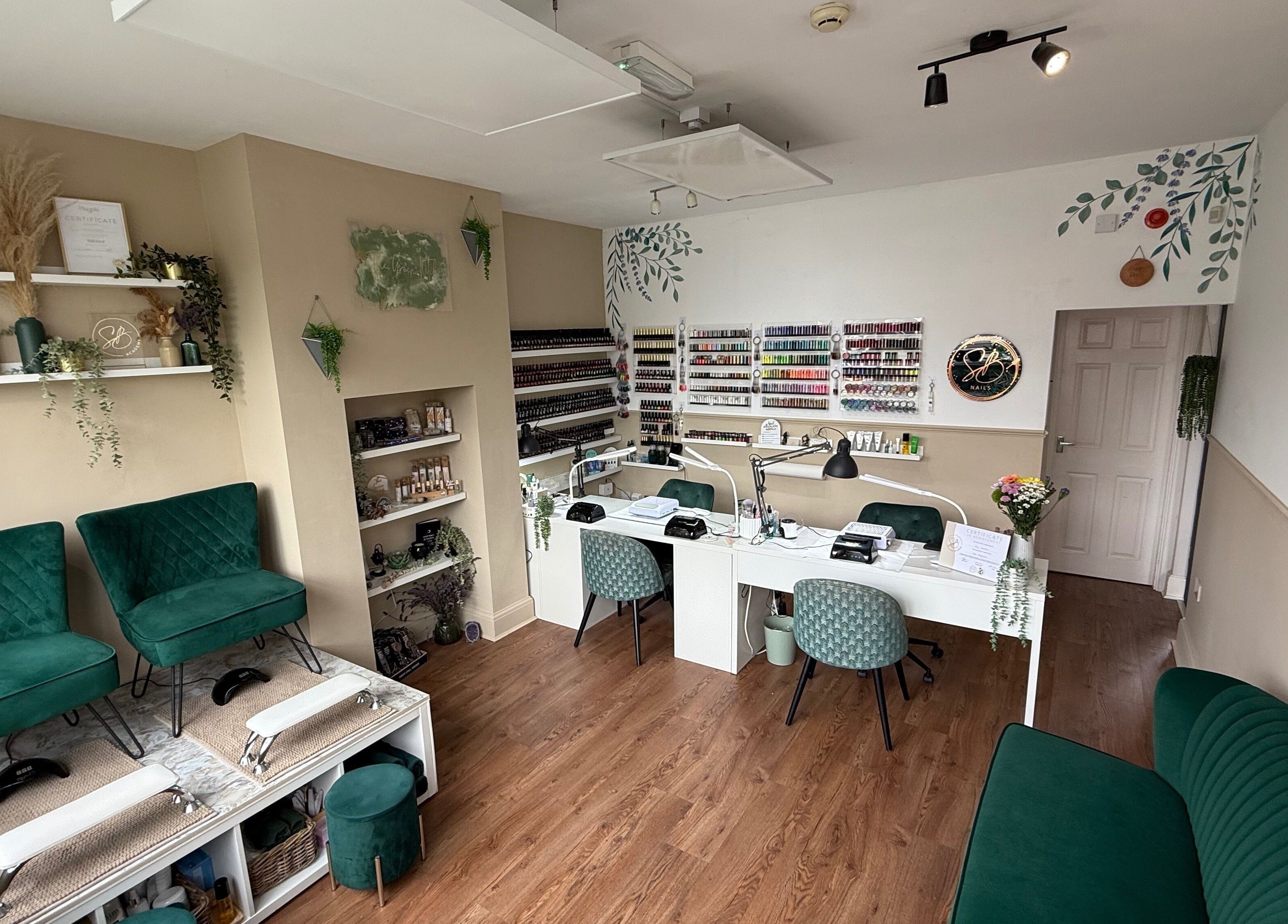 Chic nail salon interior at SB Wellbeing / SB Academy, Chesterfield, England, GB featuring stylish seating and polish display.