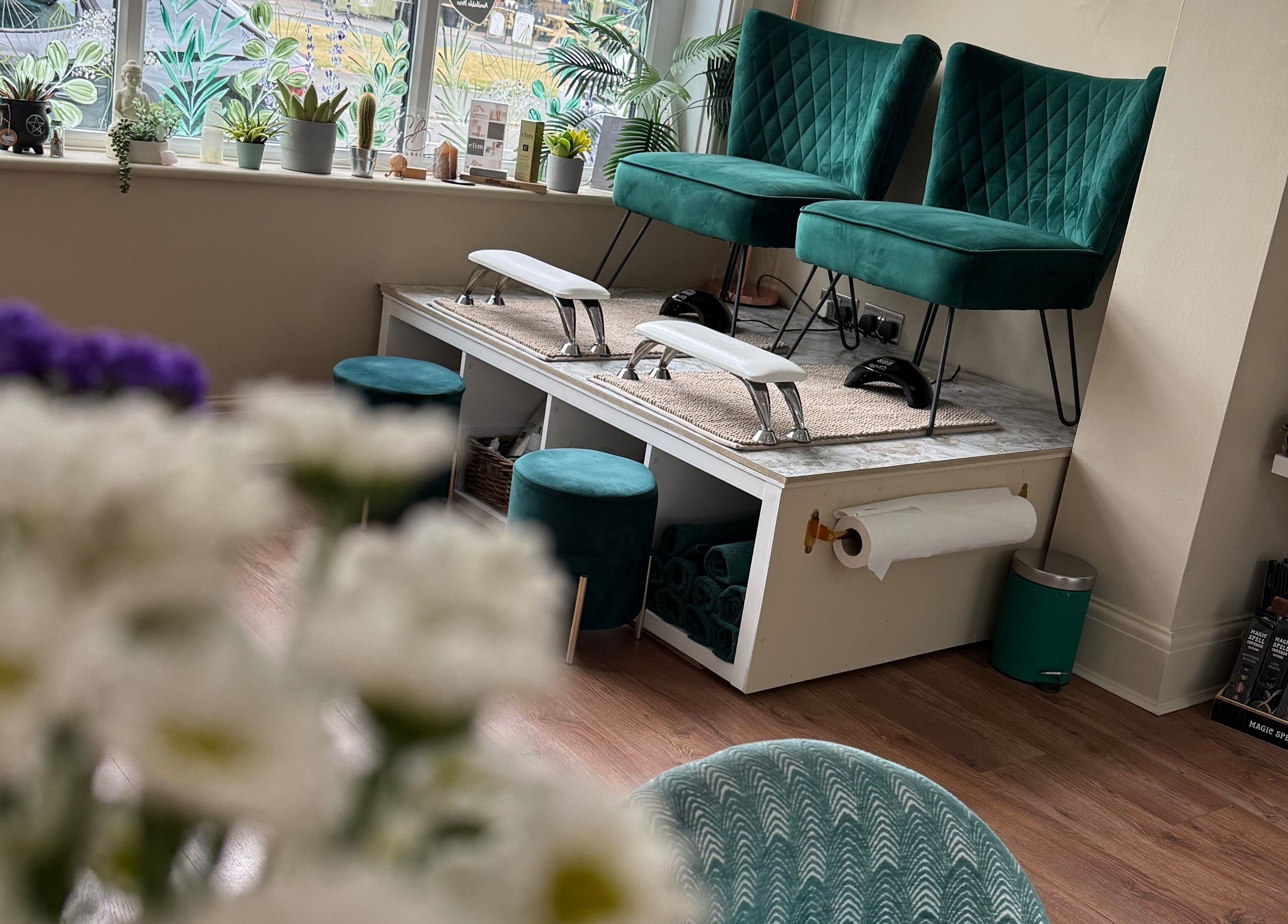 Elegant pedicure station at SB Wellbeing / SB Academy, Chesterfield, England, GB with green chairs and plants.