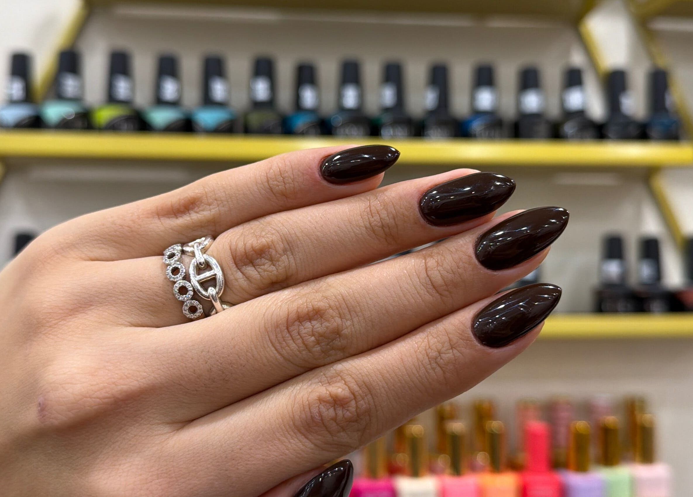 Glossy dark nails with rings at Nails by Ruzan, Glendale, California, US.