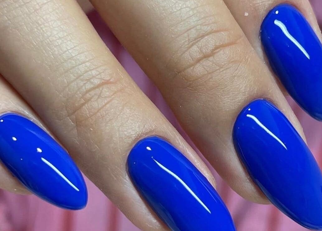 Vivid blue nails at Nails by Ruzan in Glendale, California, US showcasing glossy manicure style.