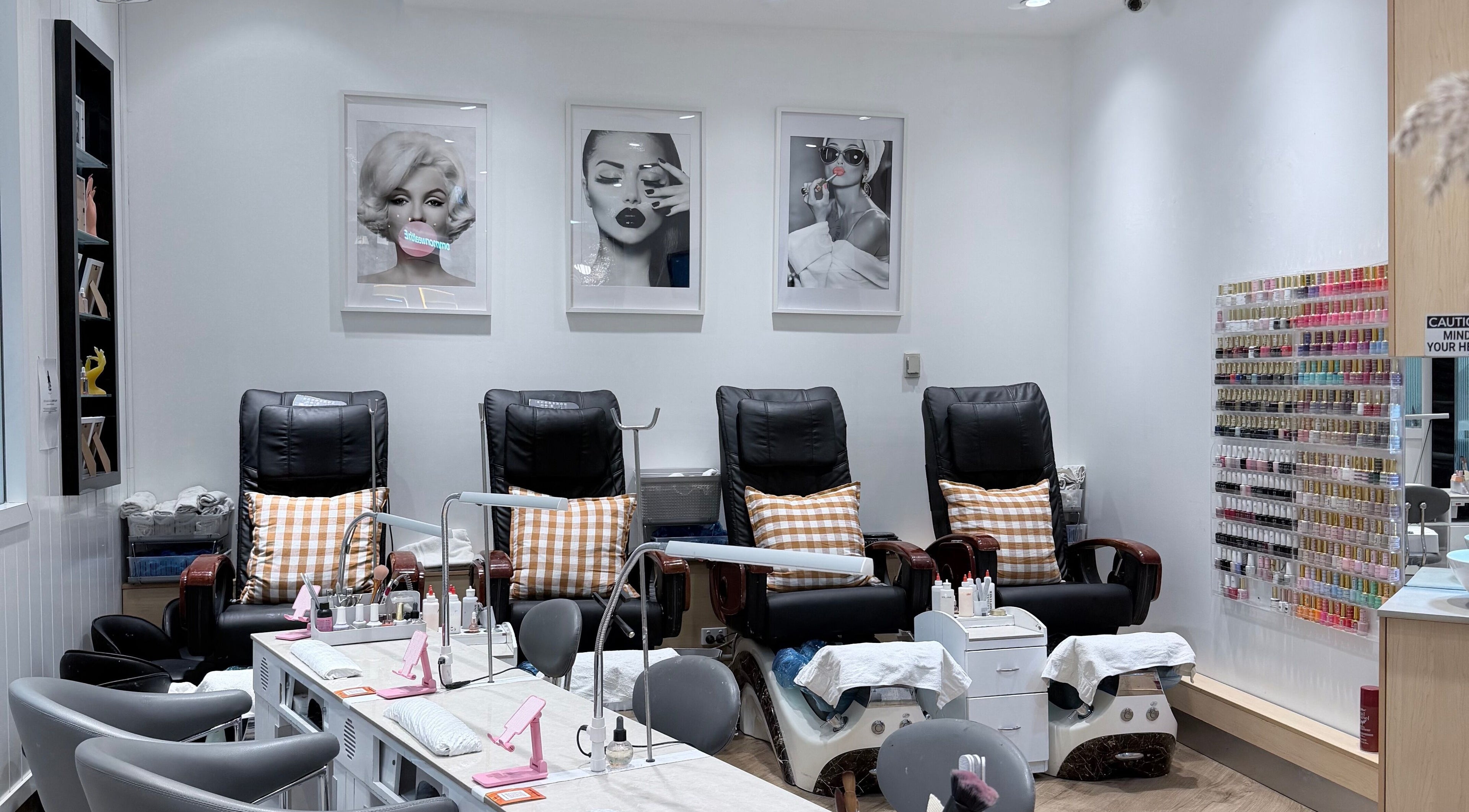 Elegant pedicure station at Pearl Nails And Beauty Carlingford, Carlingford, New South Wales, AU featuring comfortable chairs and colorful nail polishes.