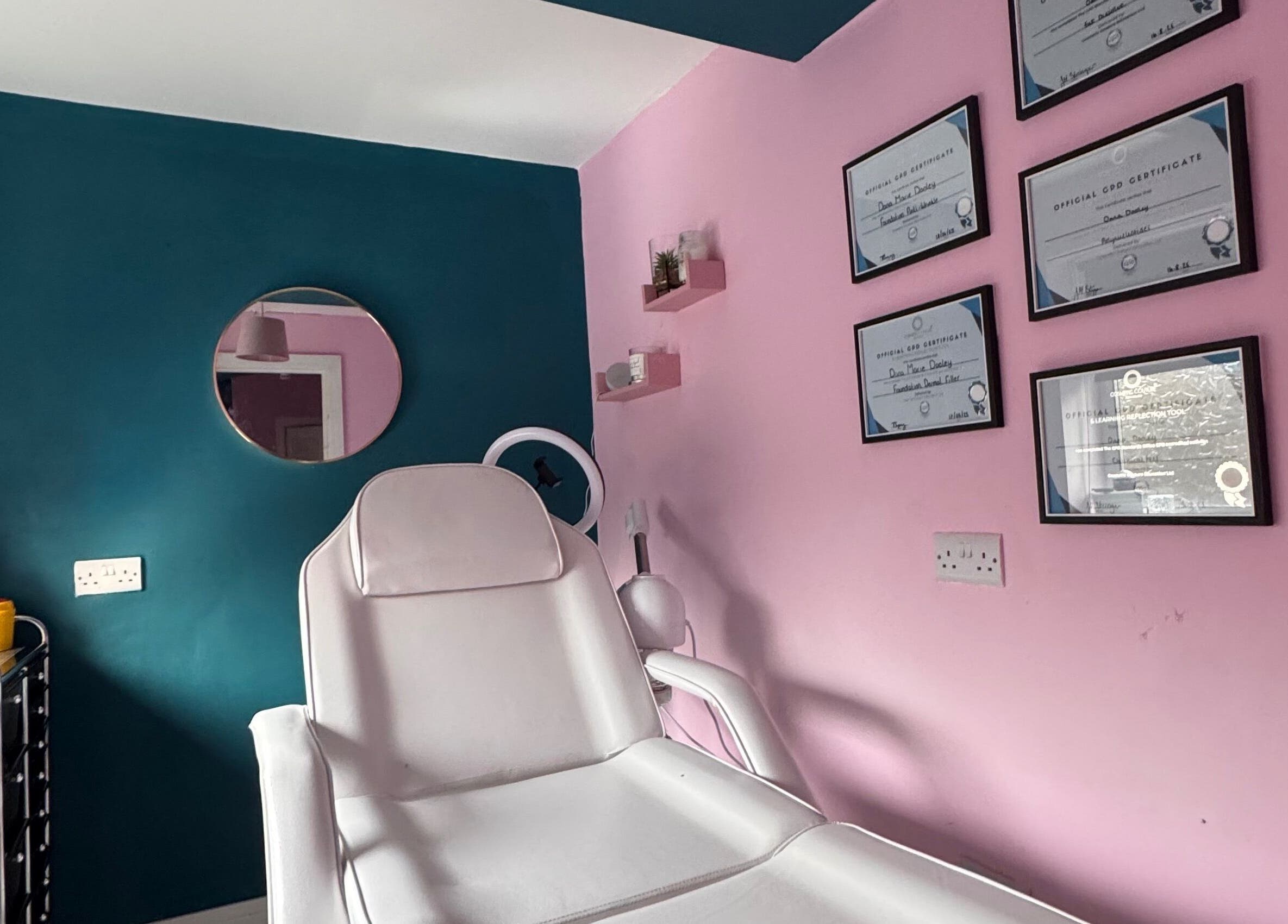 Modern treatment room at DMD Aesthetics, Eccles, England, GB with certificates and a stylish design.