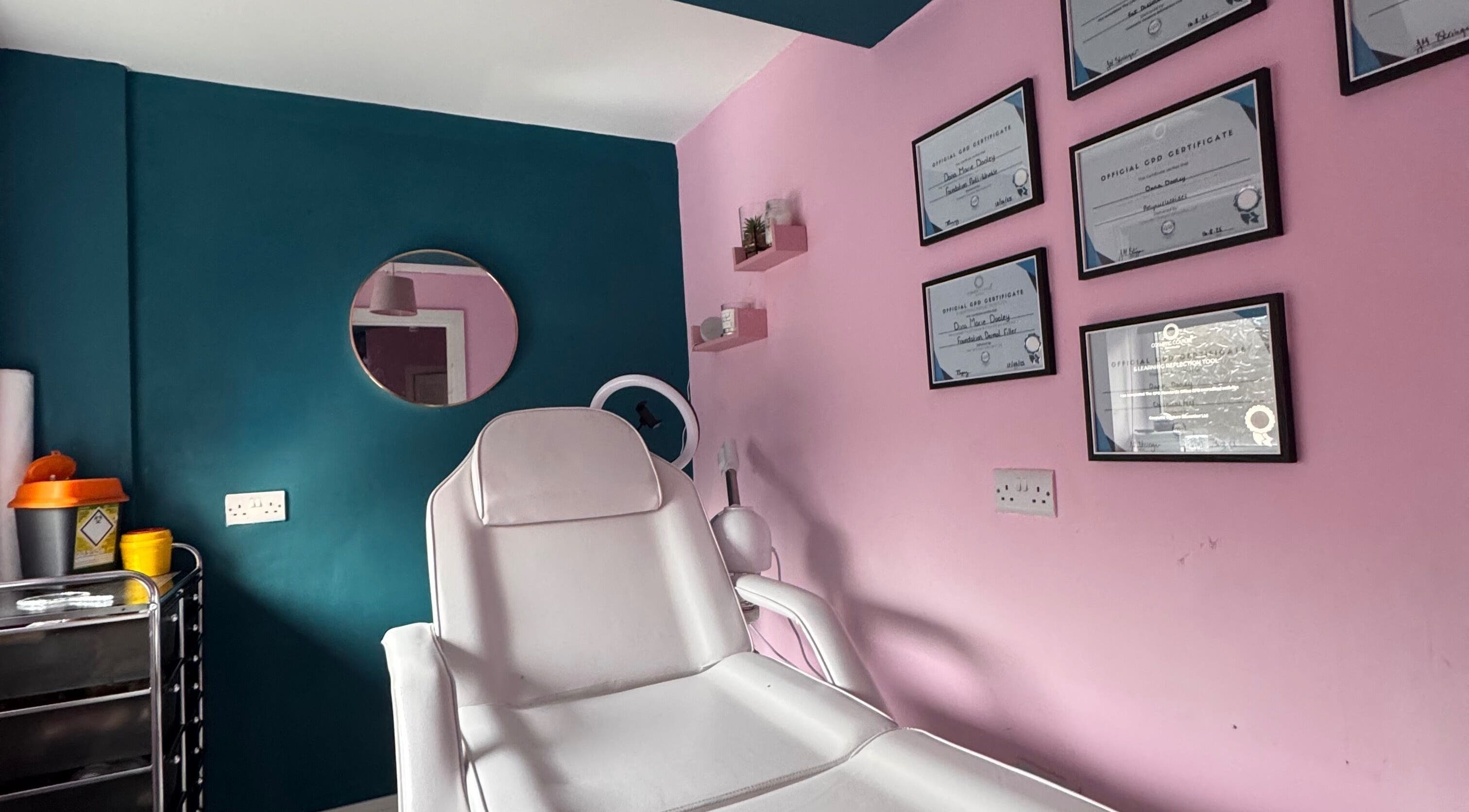 Modern treatment room at DMD Aesthetics, Eccles, England, GB with certificates and a stylish design.