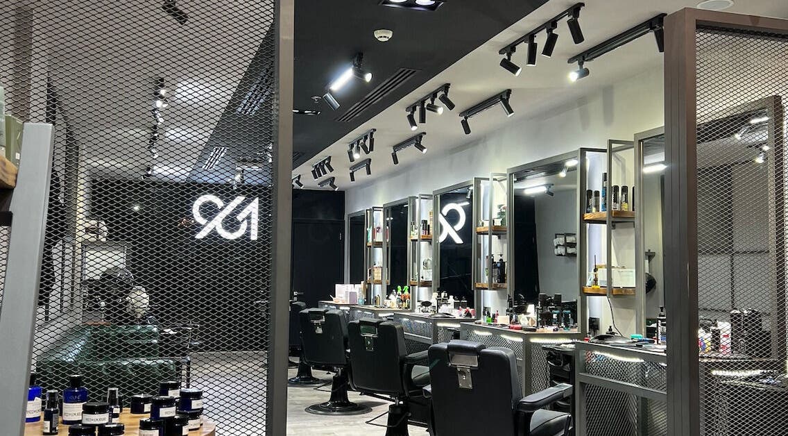 Modern interior of 961 Salon in Doha, Doha Municipality, QA, showcasing stylish hair stations and sleek design.