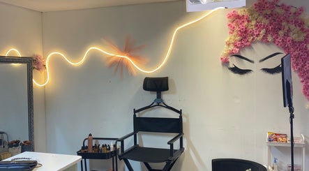 Makeup studio at Beauty by Orah, Cape Town, Western Cape, ZA, featuring chic lighting and floral wall art.