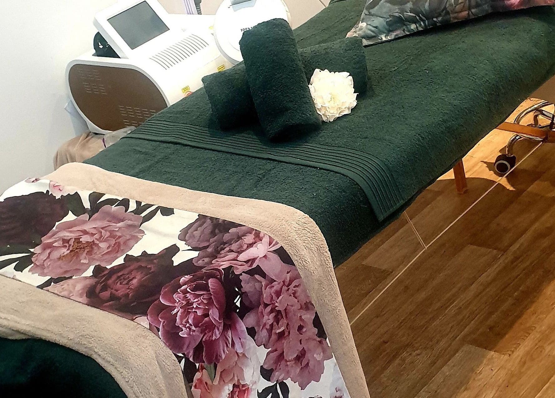 Spa bed with floral sheets at Eternal Beauty, Johannesburg, Gauteng, ZA, offering a tranquil ambiance.