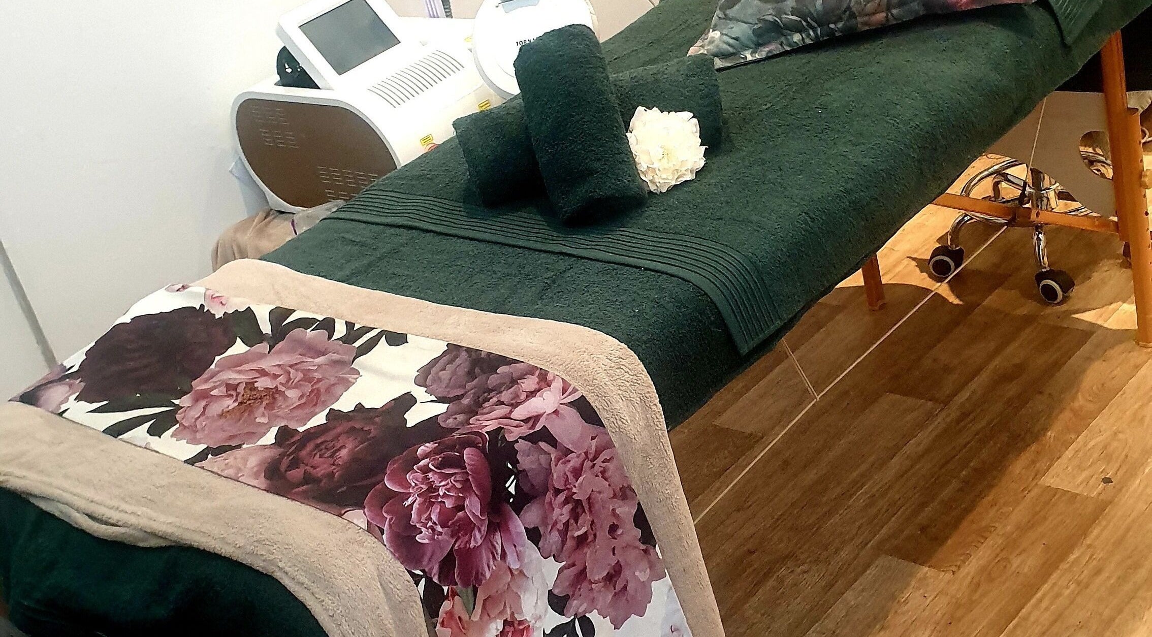 Spa bed with floral sheets at Eternal Beauty, Johannesburg, Gauteng, ZA, offering a tranquil ambiance.