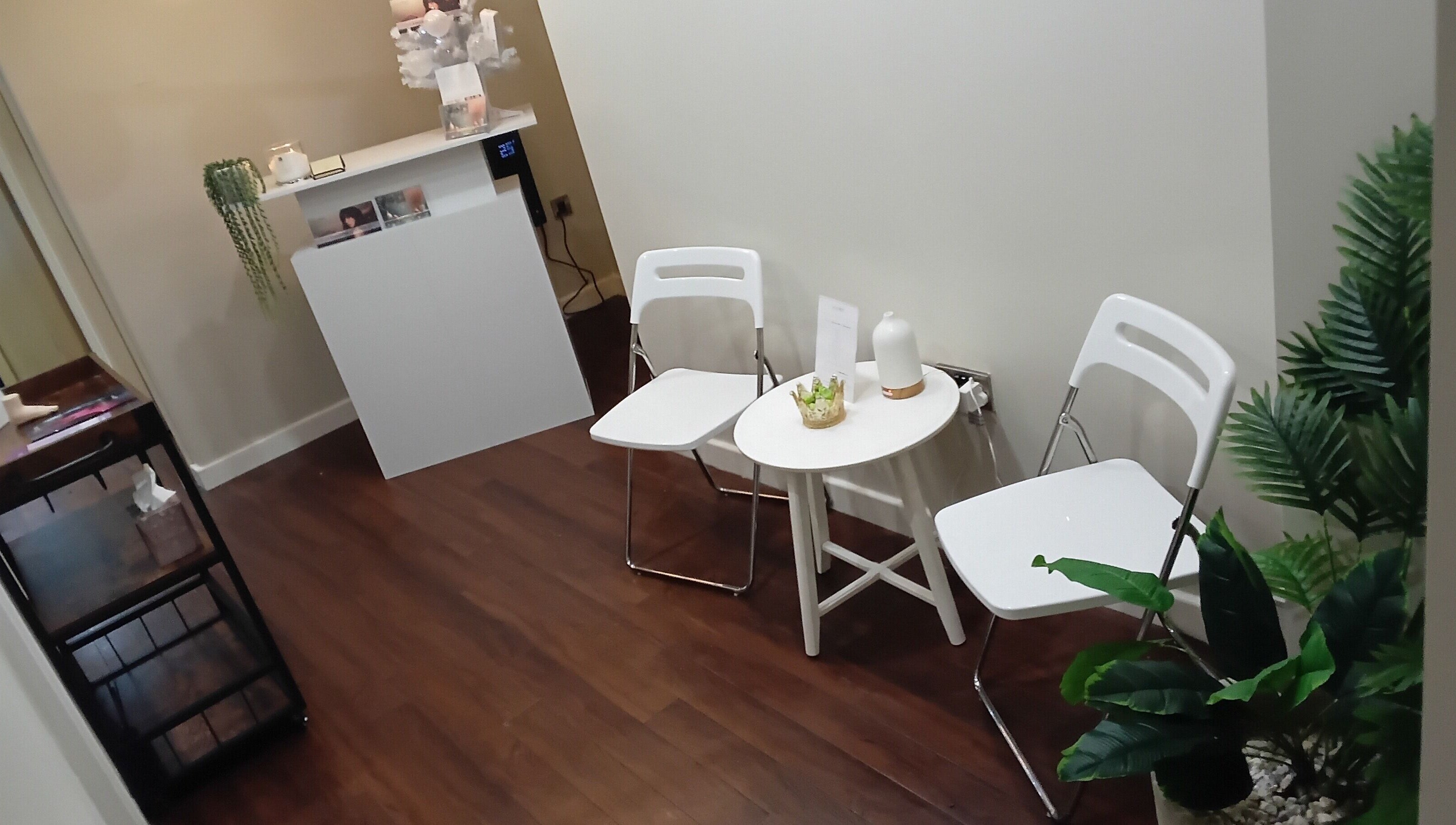 Cozy waiting area at RK Skin & Sole Ltd, Leeds, England, GB with chairs, table, and plants.