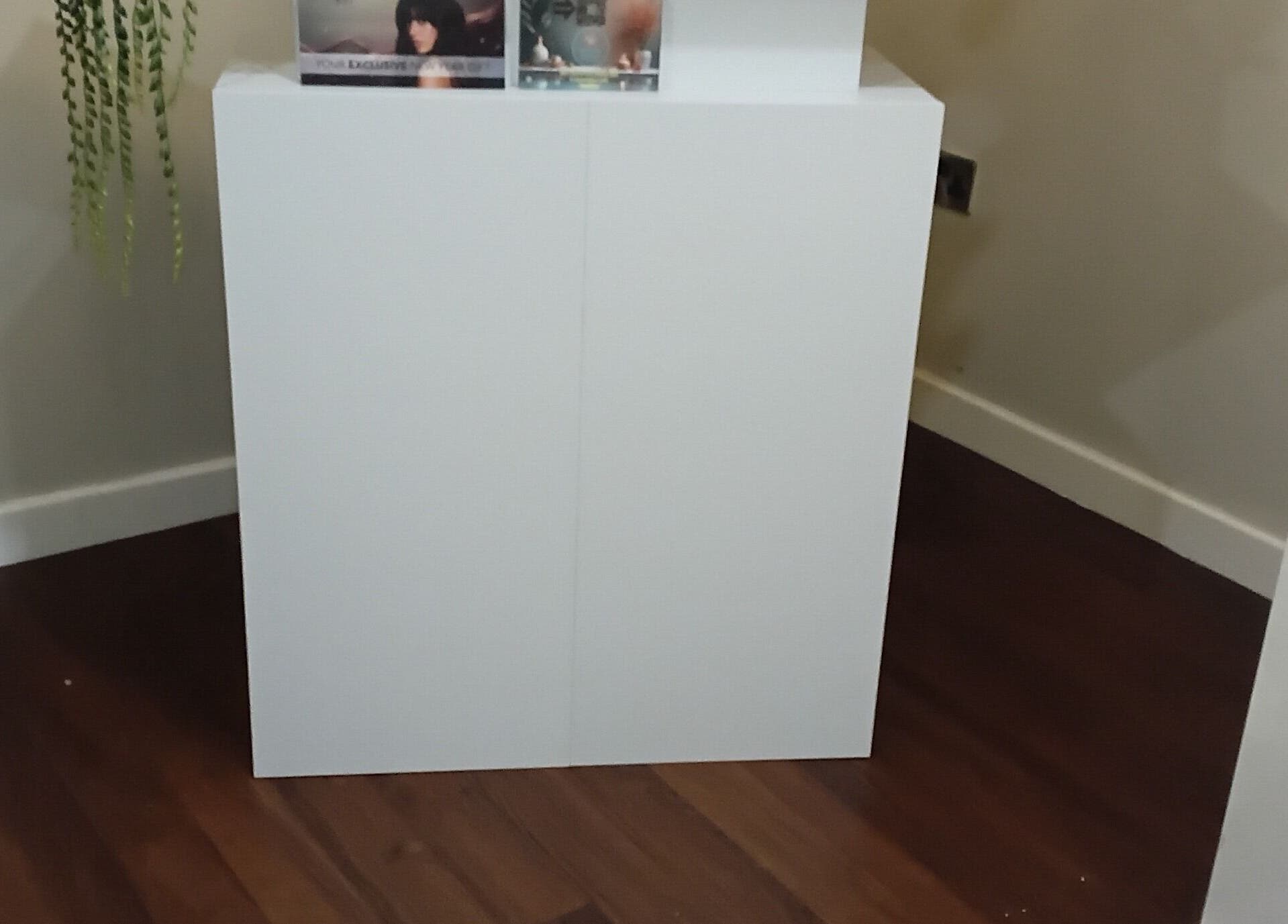 Minimalist white reception desk at RK Skin & Sole Ltd, Leeds, England, GB with sleek wooden floor.