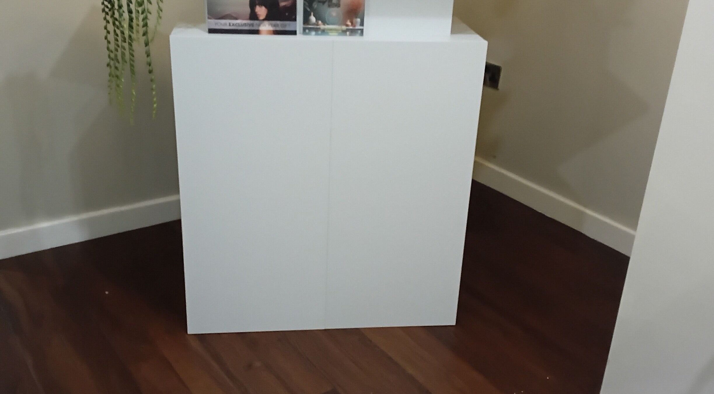 Minimalist white reception desk at RK Skin & Sole Ltd, Leeds, England, GB with sleek wooden floor.