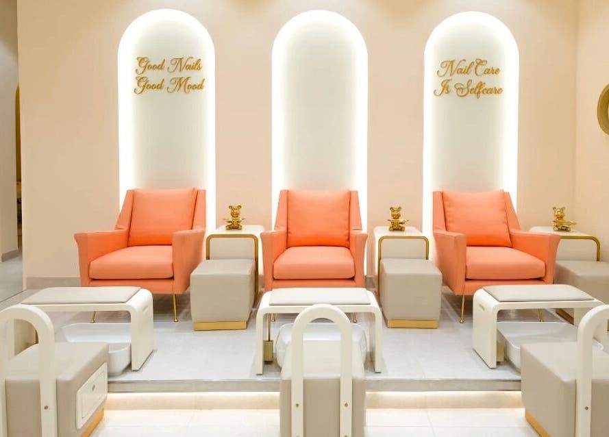 Elegant peach chairs at Flourish Beauty Lounge & Spa, Dubai, AE nail care area with modern decor.