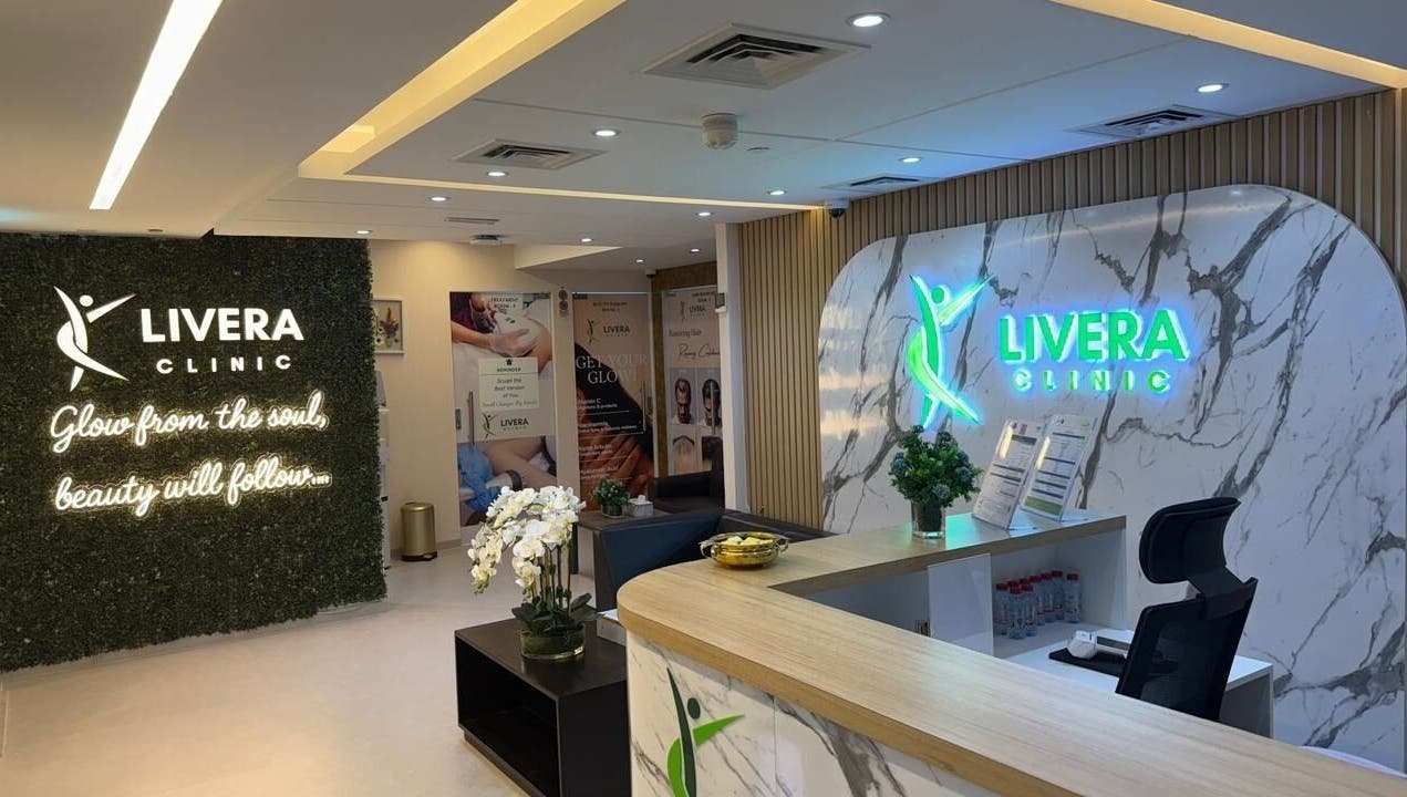 Reception area of Livera Aesthetic Clinic, Dubai, AE, featuring modern design and glowing signage.