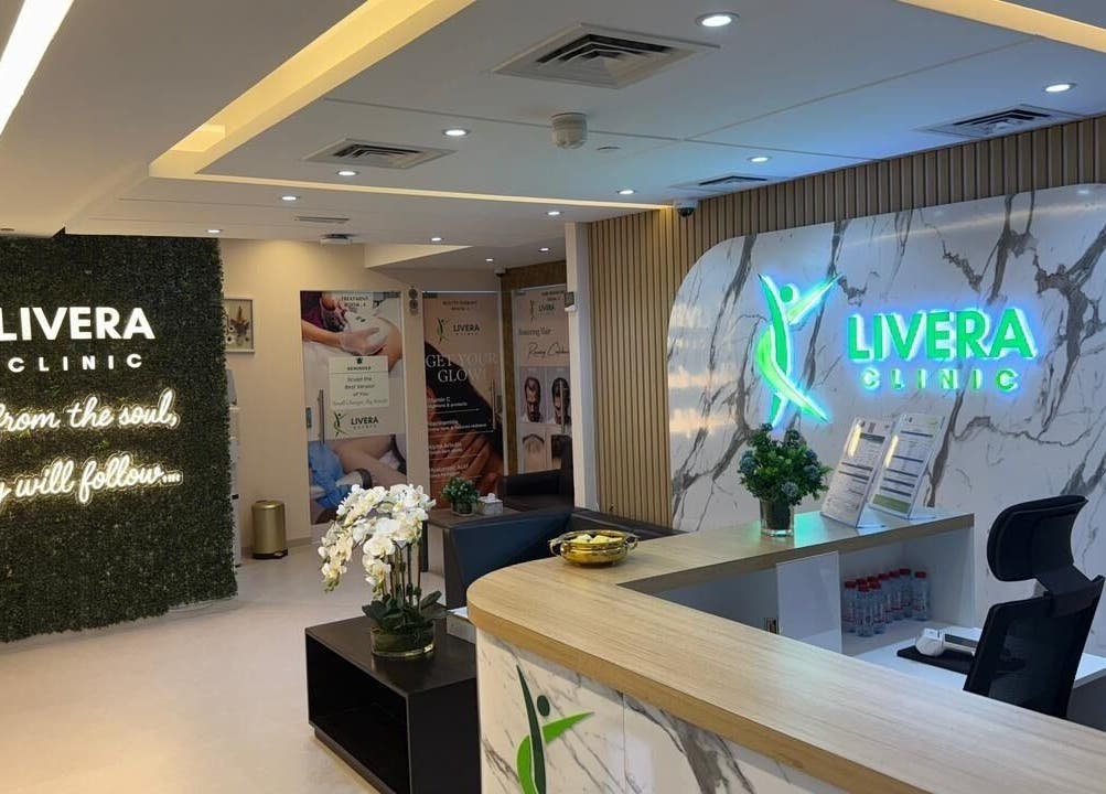 Reception area of Livera Aesthetic Clinic, Dubai, AE, featuring modern design and glowing signage.