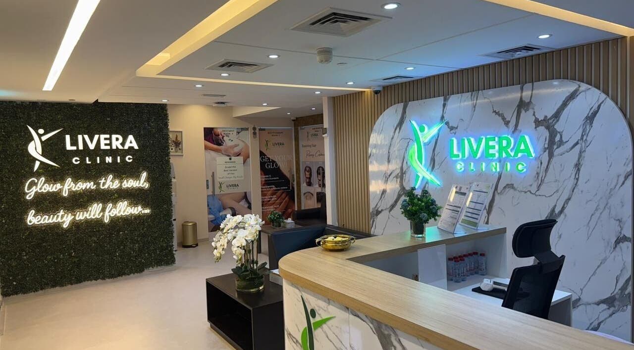 Reception area of Livera Aesthetic Clinic, Dubai, AE, featuring modern design and glowing signage.