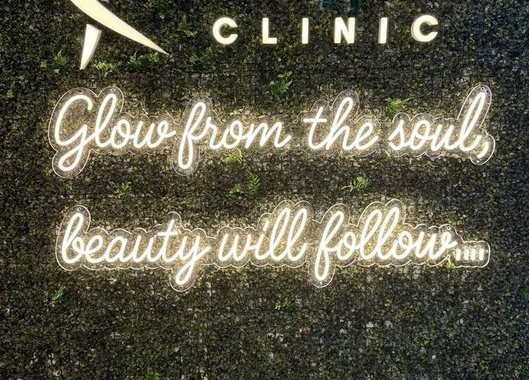 Inspirational quote on a green wall at Livera Aesthetic Clinic, Dubai, AE, saying 'Glow from the soul, beauty will follow.'