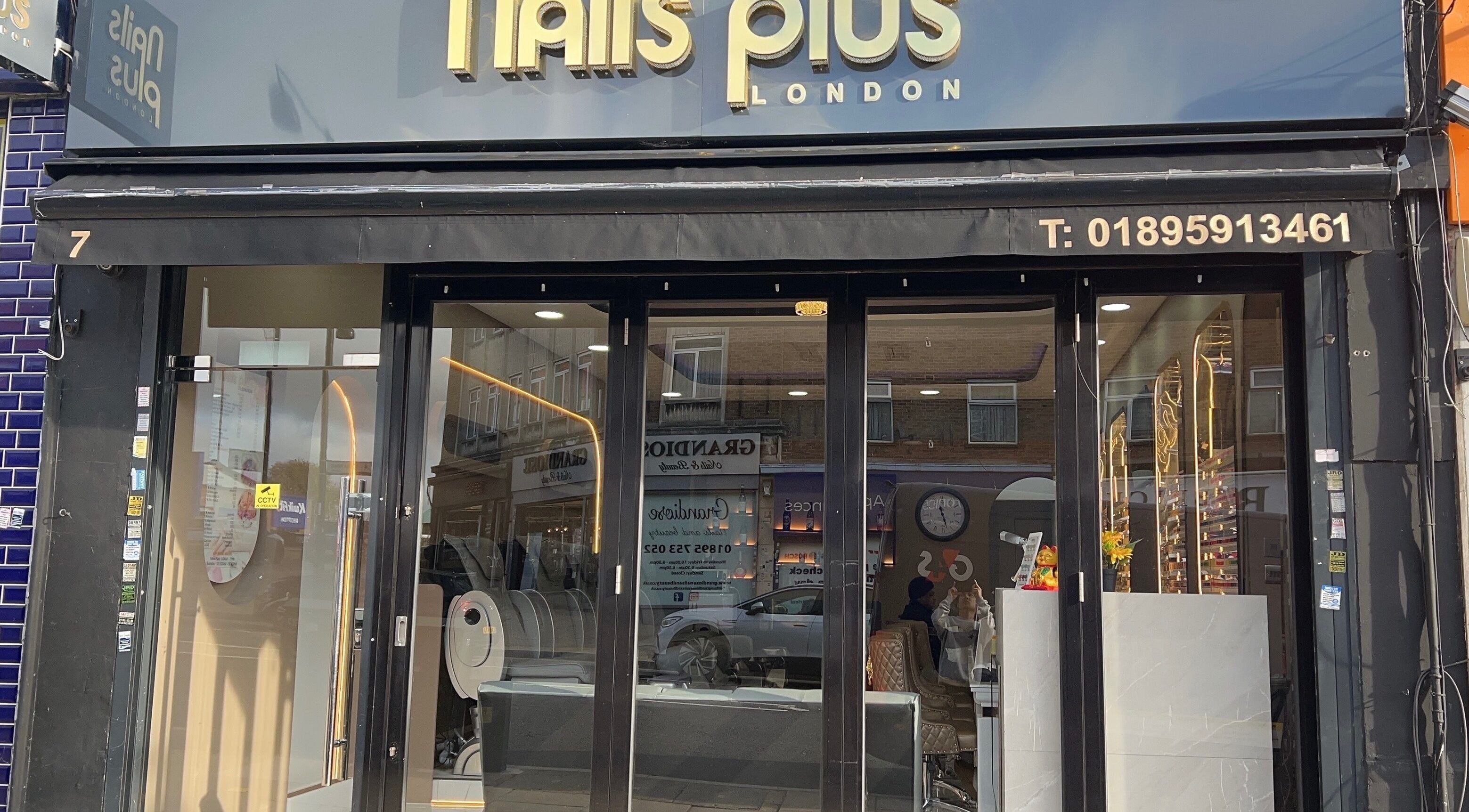 Front view of Nails Plus in Ruislip, England, showcasing a modern glass storefront with elegant signage.