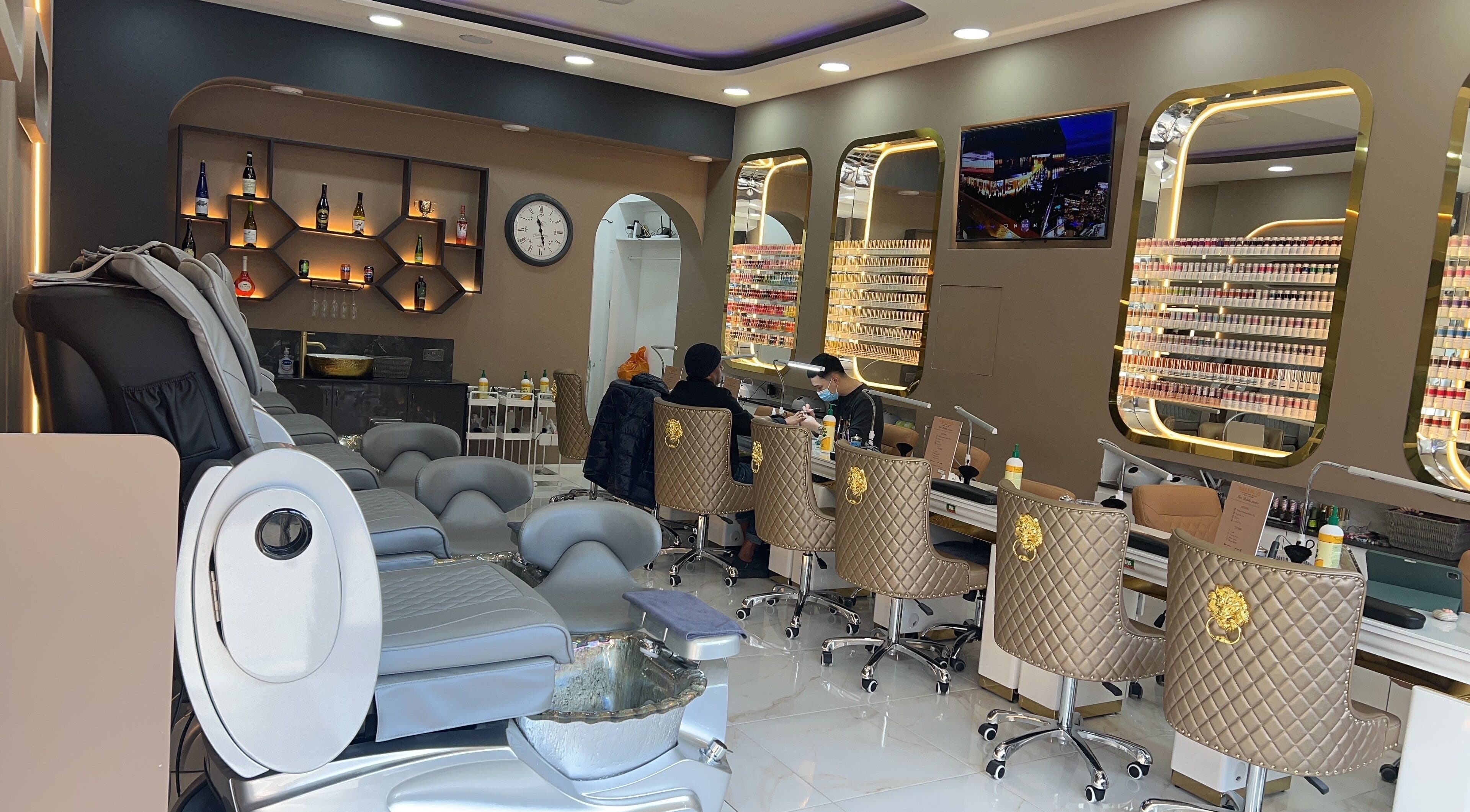 Luxurious interior of Nails Plus in Ruislip, England, GB with stylish chairs and nail polish display.