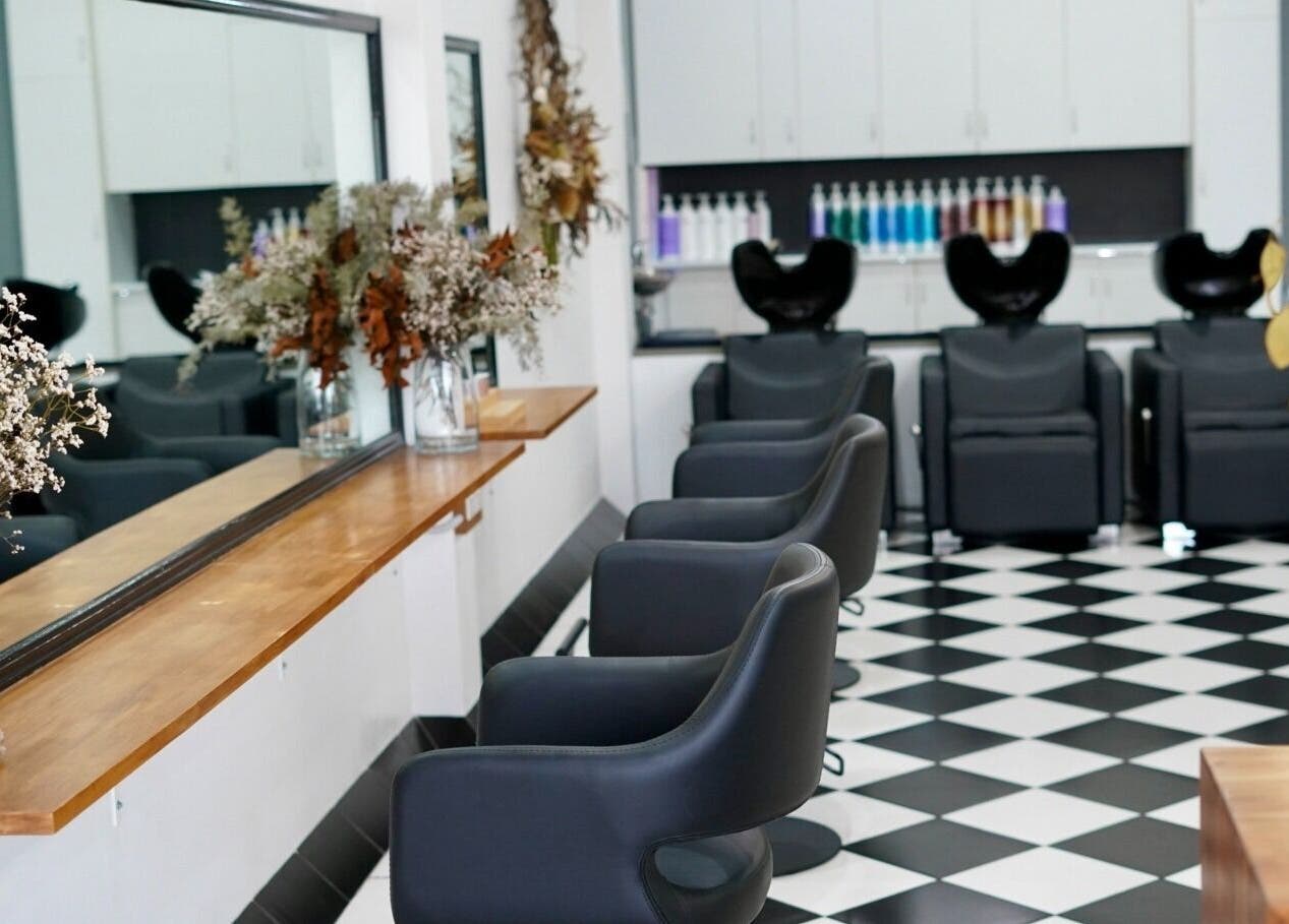 Stylish interior of Laura Jane Hair in Waratah, New South Wales, AU with chic salon furniture and decor.