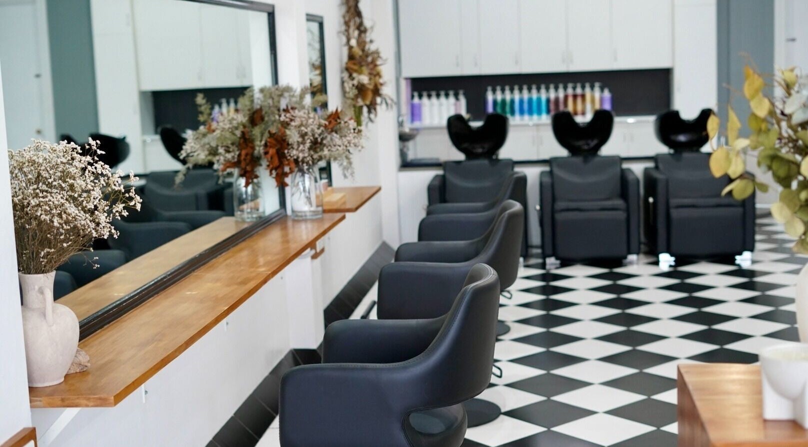 Stylish interior of Laura Jane Hair in Waratah, New South Wales, AU with chic salon furniture and decor.