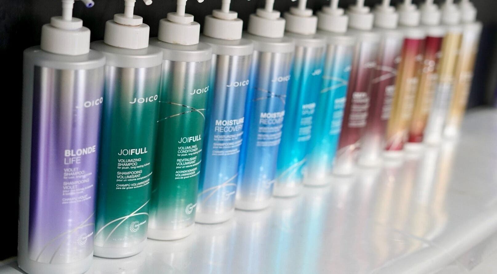 Colorful Joico shampoo bottles at Laura Jane Hair, Waratah, New South Wales, AU with vibrant energy.
