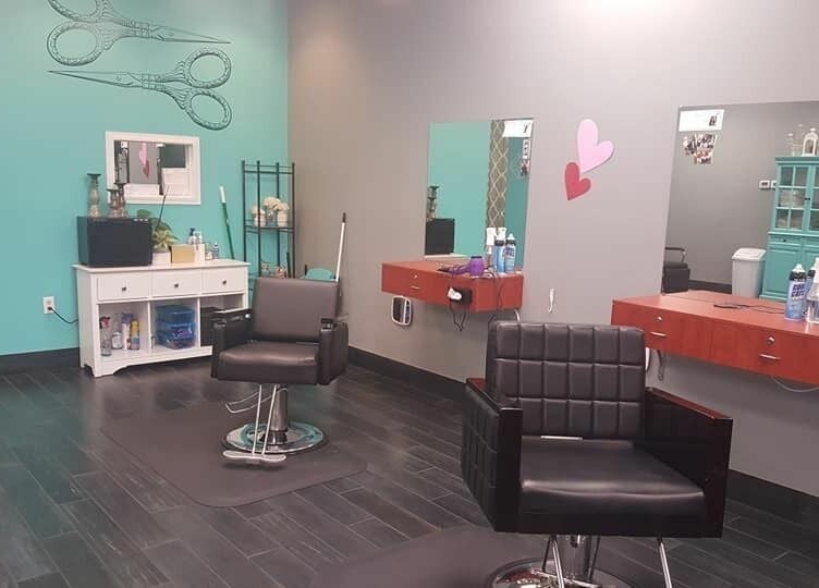 Modern salon interior at The Clip Joint, Yelm, Washington, US with stylish chairs and teal accents.