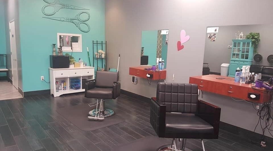 Modern salon interior at The Clip Joint, Yelm, Washington, US with stylish chairs and teal accents.