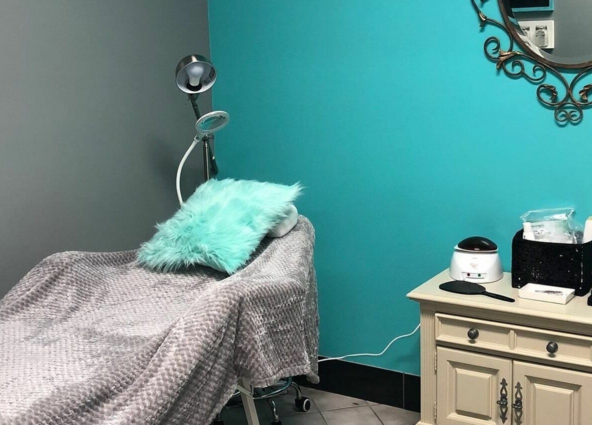A calming treatment room at The Clip Joint in Yelm, Washington, US, featuring a plush bed and elegant decor.