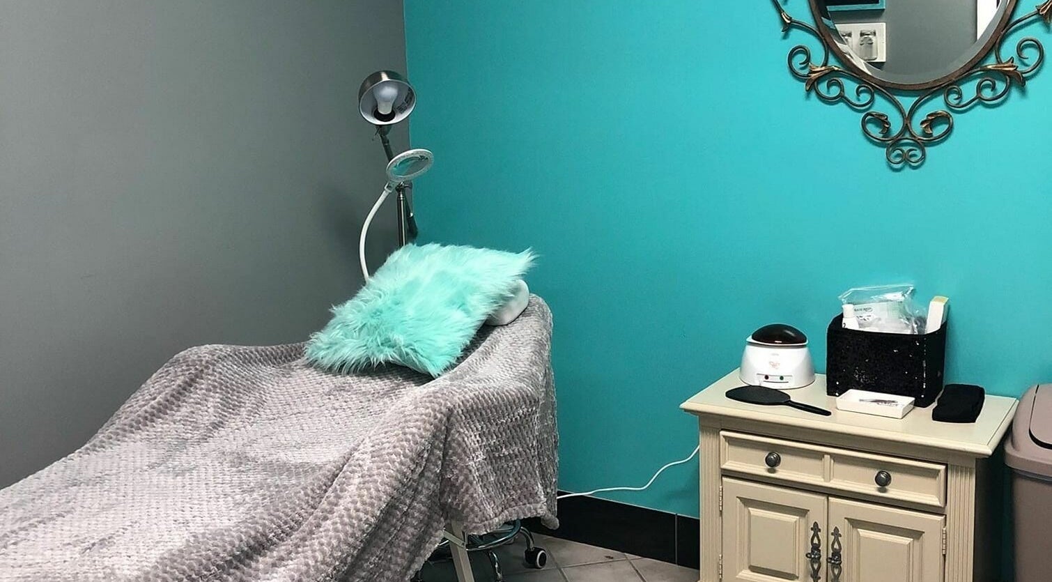 A calming treatment room at The Clip Joint in Yelm, Washington, US, featuring a plush bed and elegant decor.