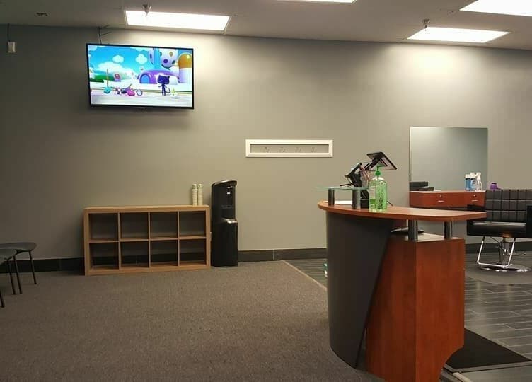Modern interior of The Clip Joint salon in Yelm, Washington, US with a stylish seating area and reception.