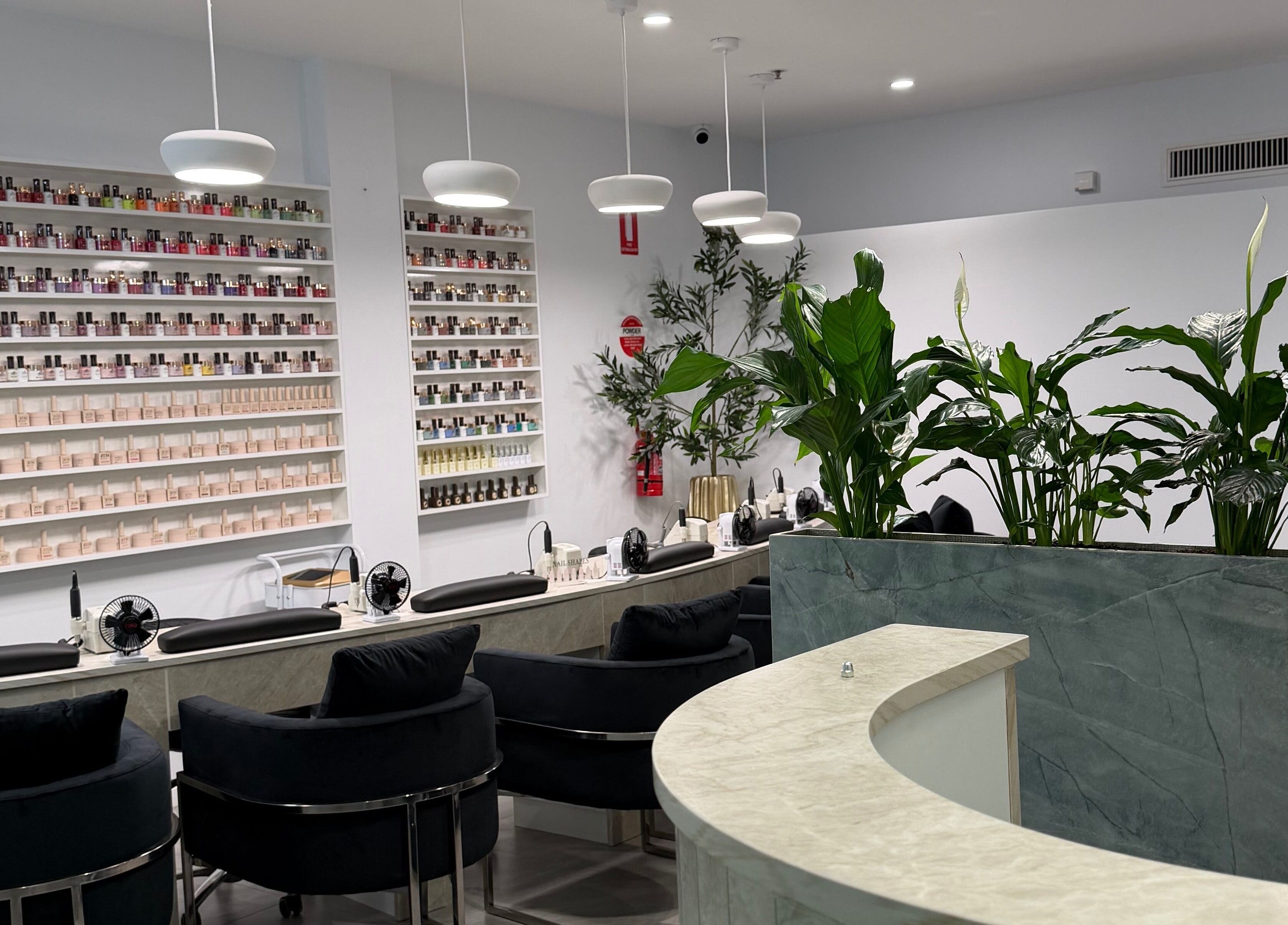 Elegant nail salon interior at Best Nails Ever, Melbourne, Victoria, AU with stylish seating and polish display.