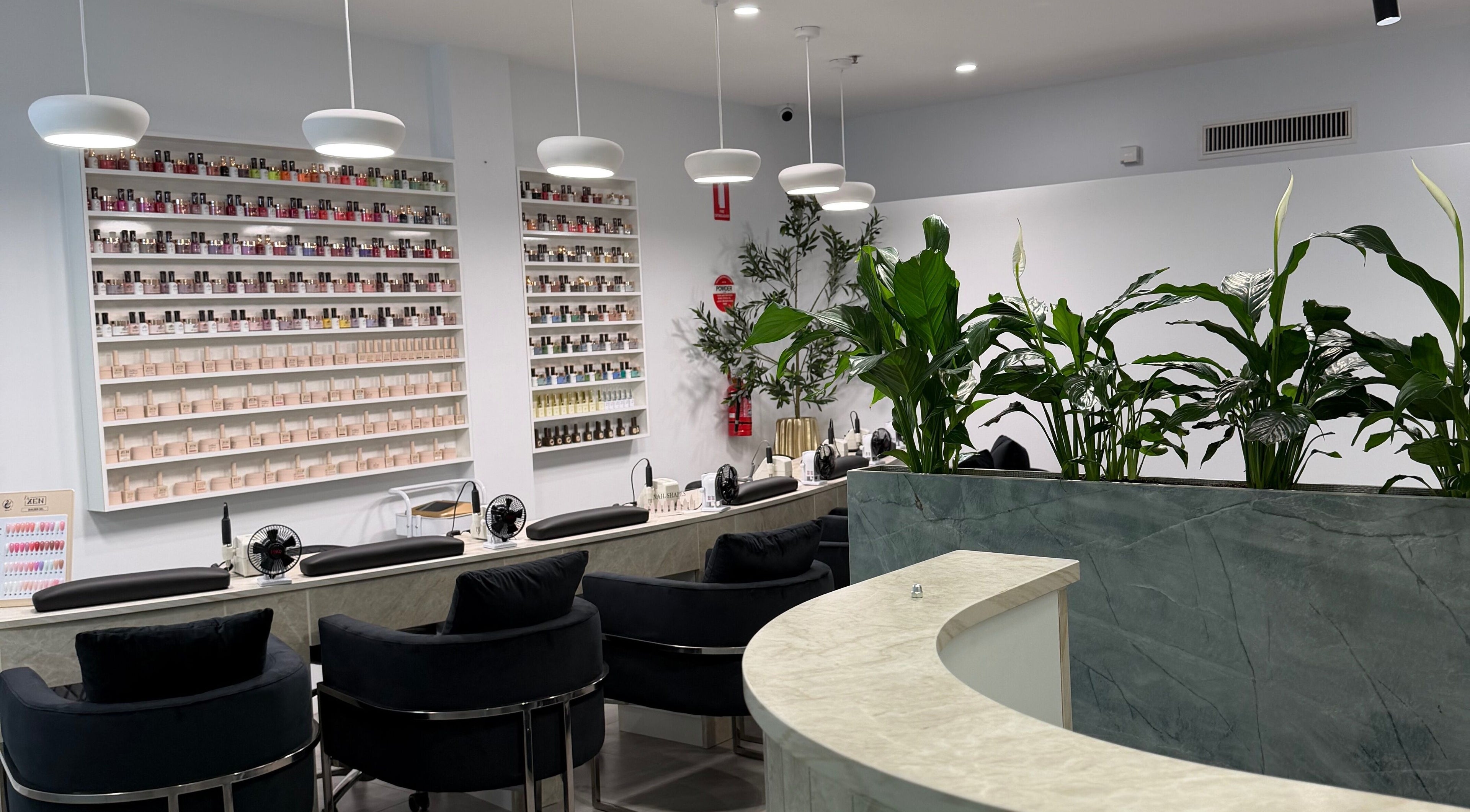 Elegant nail salon interior at Best Nails Ever, Melbourne, Victoria, AU with stylish seating and polish display.