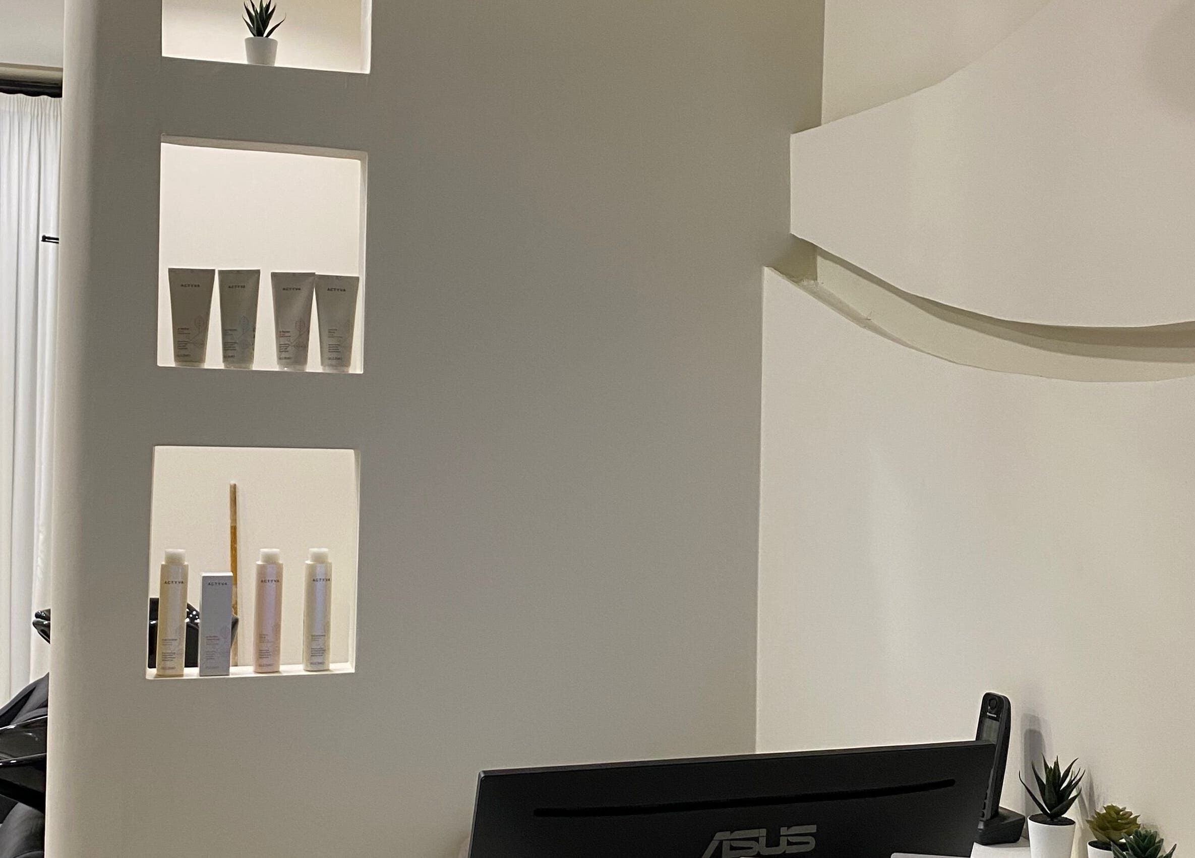 Modern salon interior at Hair & More by Hanan, Al Hidd, Muḥāfaẓat Al-muḥarraq, BH with shelves and decor.