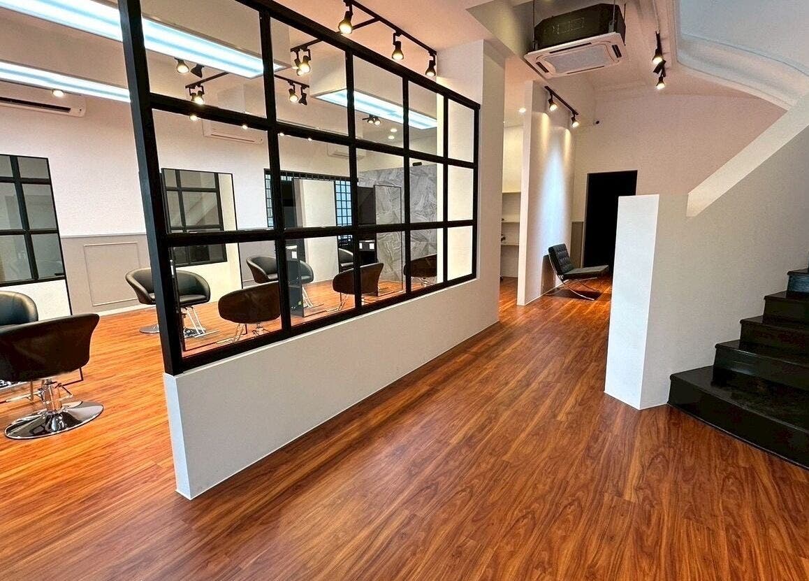 Modern salon interior at melco HairDesign, Phnom Penh, Phnom Penh, KH, featuring sleek black chairs and mirrors.