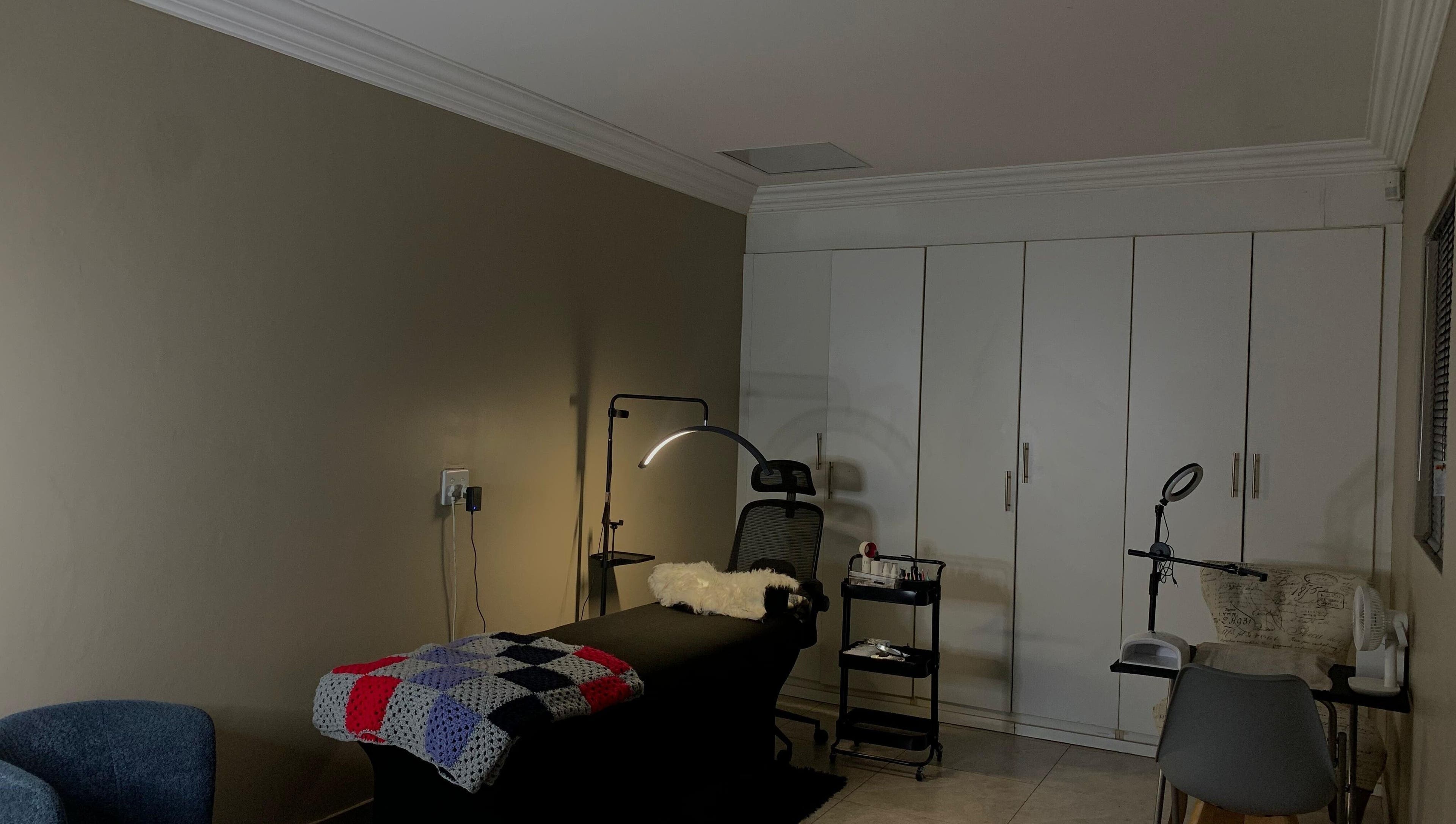 Cozy treatment room at Vinyl Vici, Pretoria, Gauteng, ZA with ambient lighting and sleek furnishings.