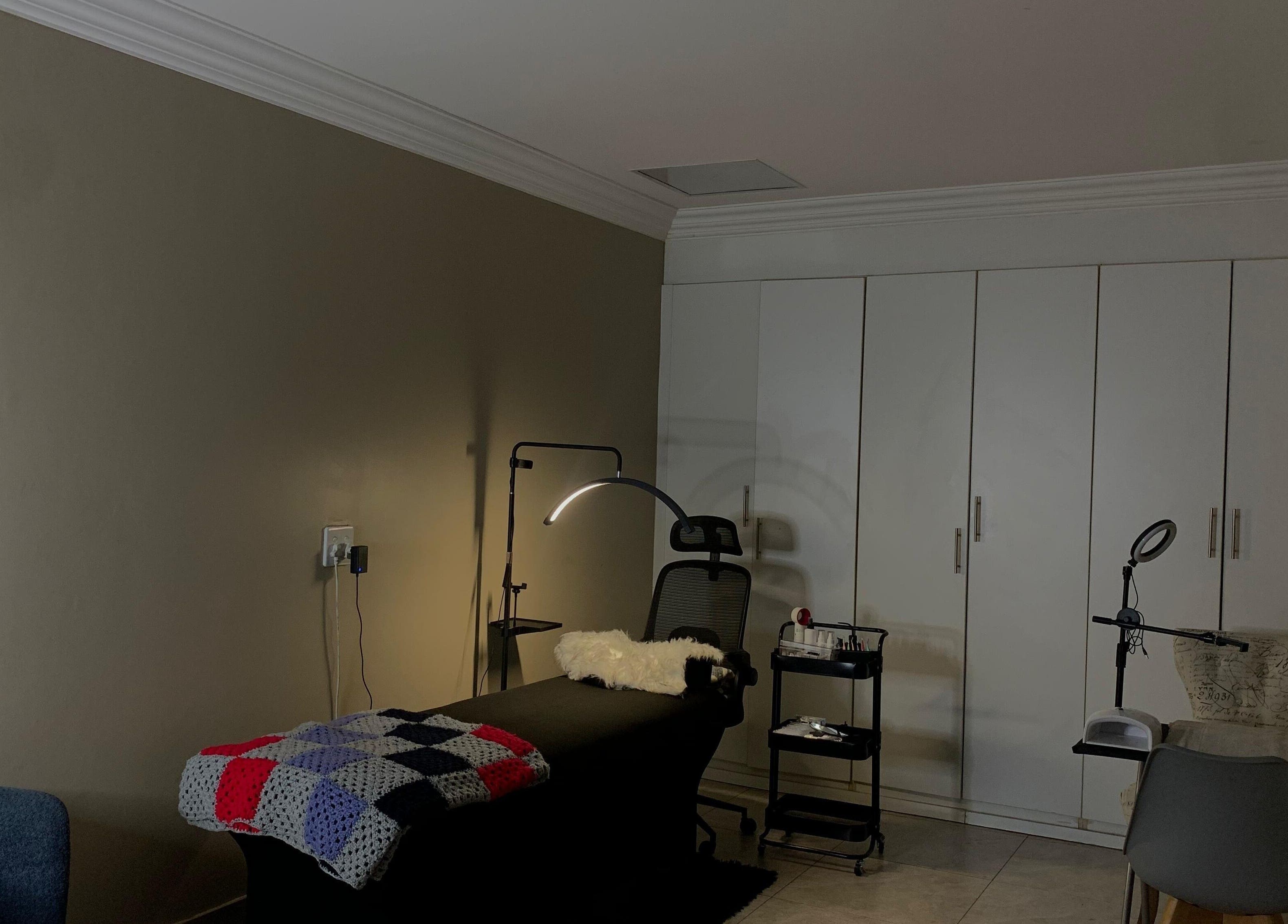 Cozy treatment room at Vinyl Vici, Pretoria, Gauteng, ZA with ambient lighting and sleek furnishings.