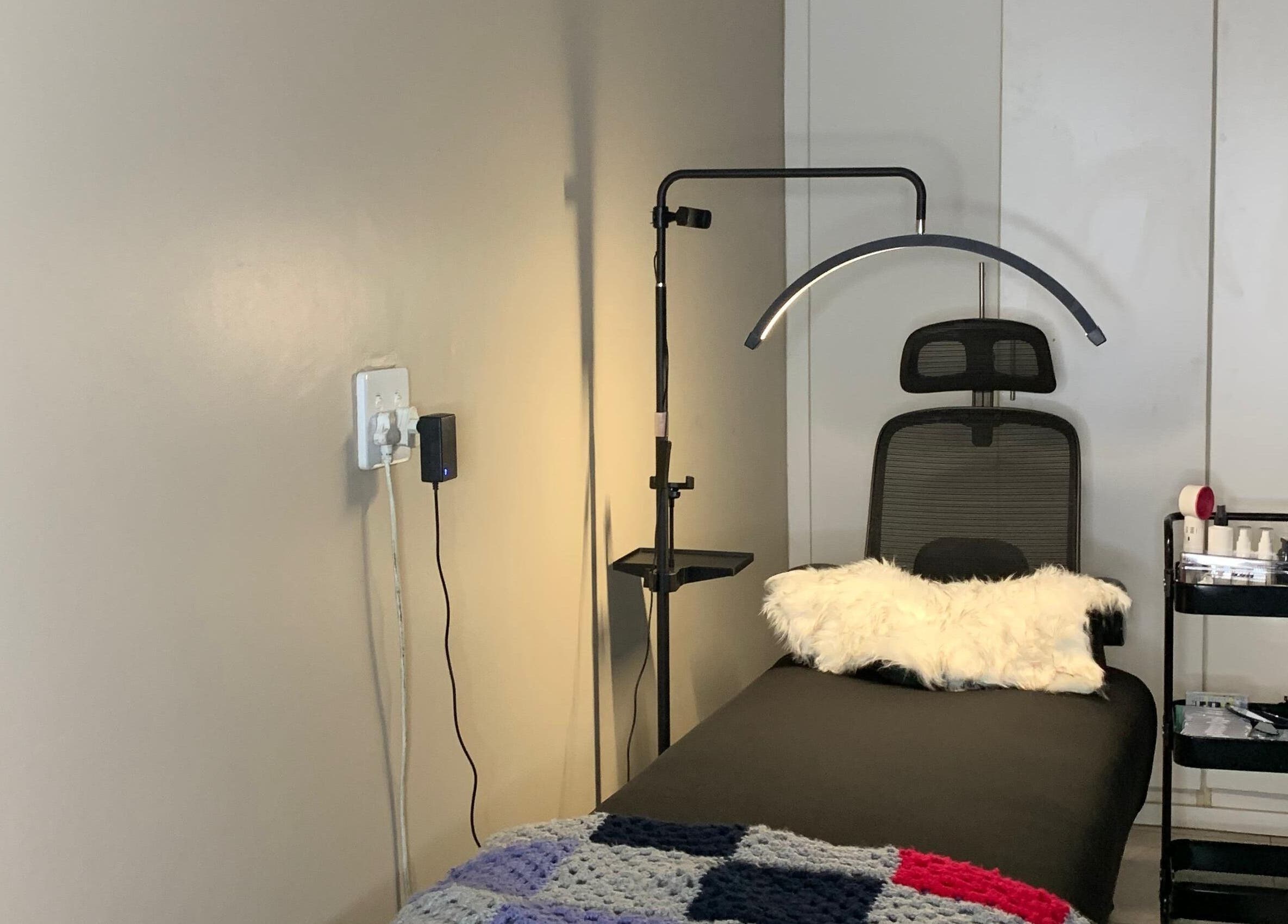 Relaxing treatment room at Vinyl Vici in Pretoria, Gauteng, ZA featuring a comfortable chair and modern decor.